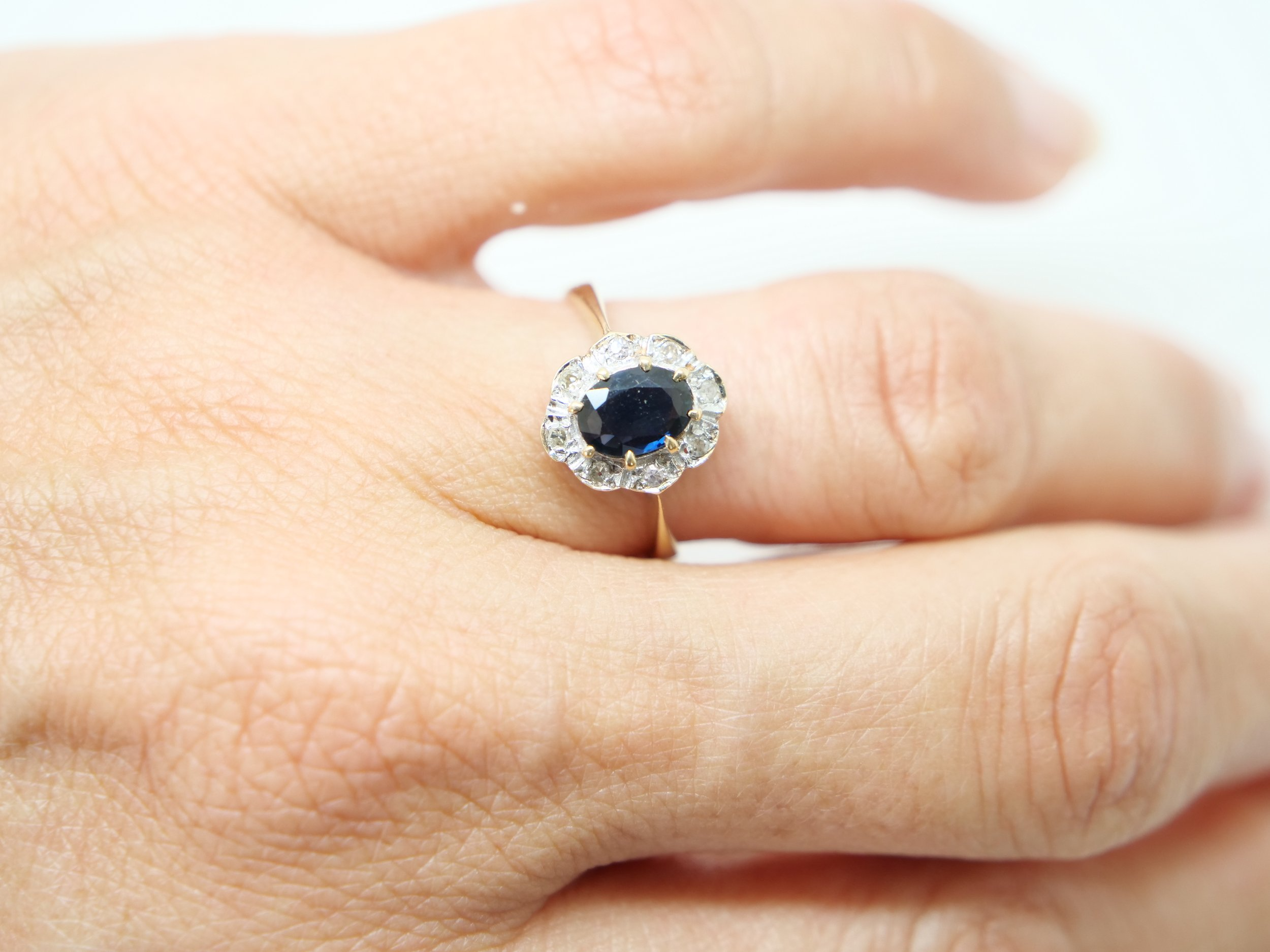 Very pretty vintage sapphire and diamond ring, set with a central oval cut sapphire of approximately 1ct and surrounded by small diamonds.