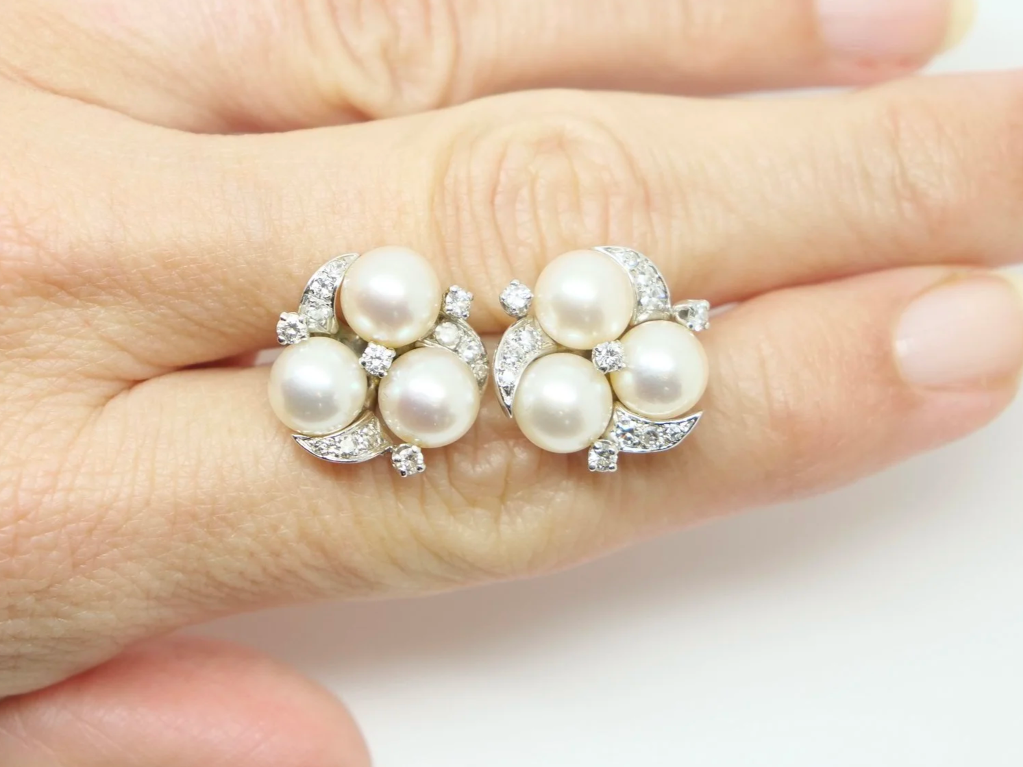 Lovely vintage pearl and diamond earrings in 14ct gold, each set with three pearls with diamonds in a lovely floral design.