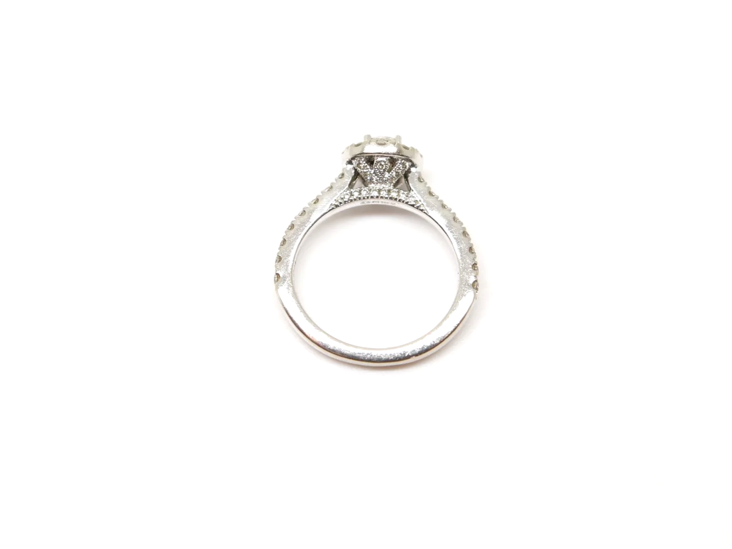 14ct white gold diamond halo ring set with a round brilliant cut diamond at the centre surrounded by a pavé-set halo of smaller diamonds