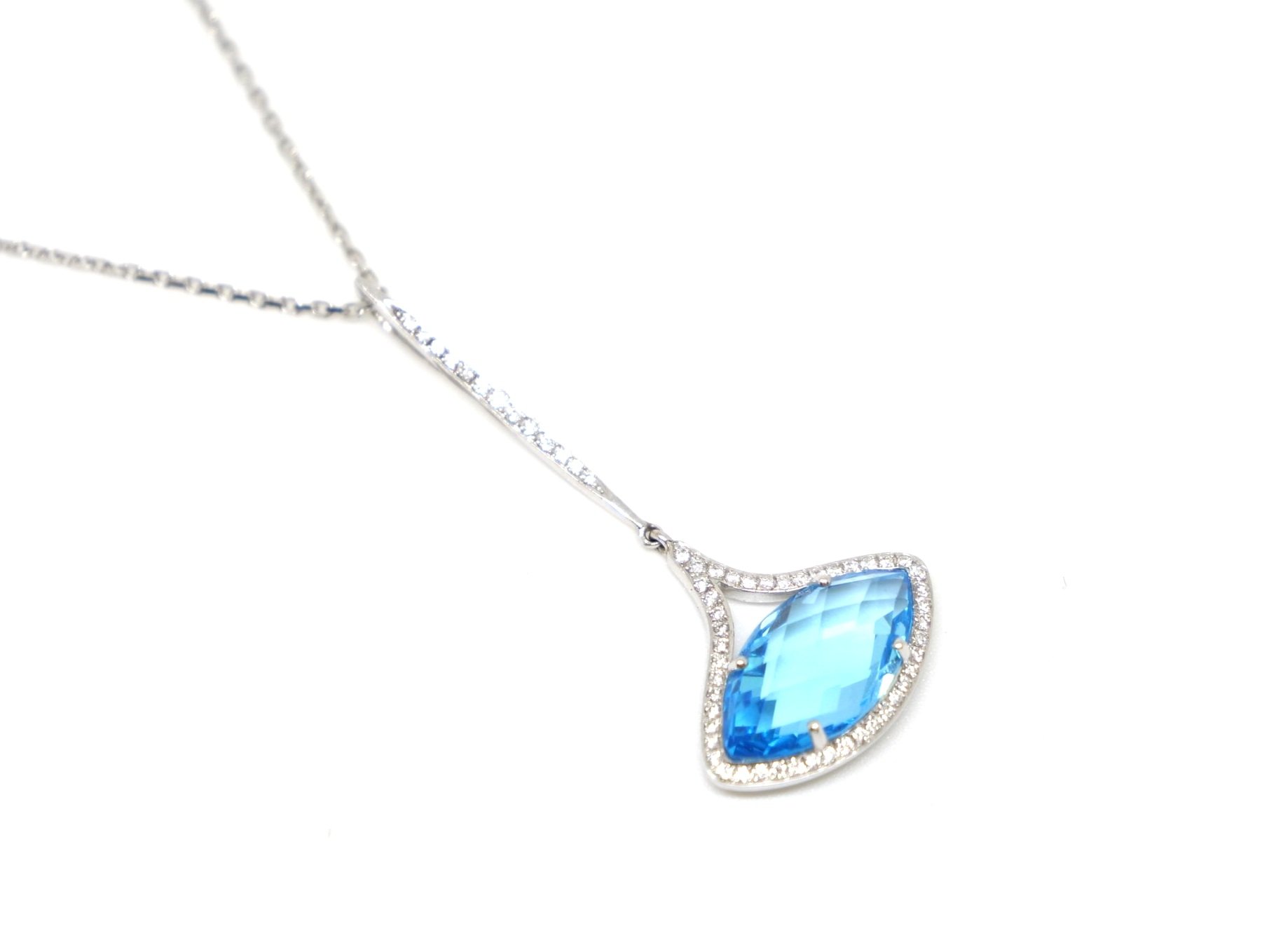 Very unusual designer style contemporary 18ct gold necklace, set with a large marquise cut blue sapphire, with diamonds both around the main gemstone and along the bale.