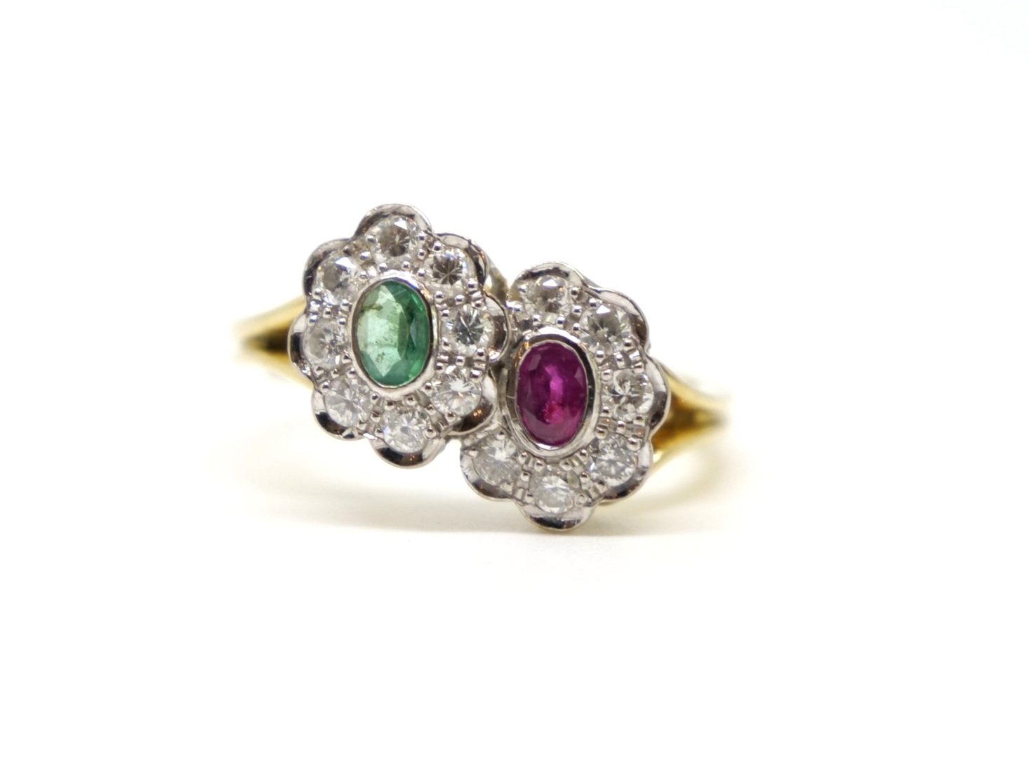 Lovely vintage 18ct gold double flower ring, one flower set with an oval cut emerald and one set with an oval cut ruby, all surrounded by diamonds.