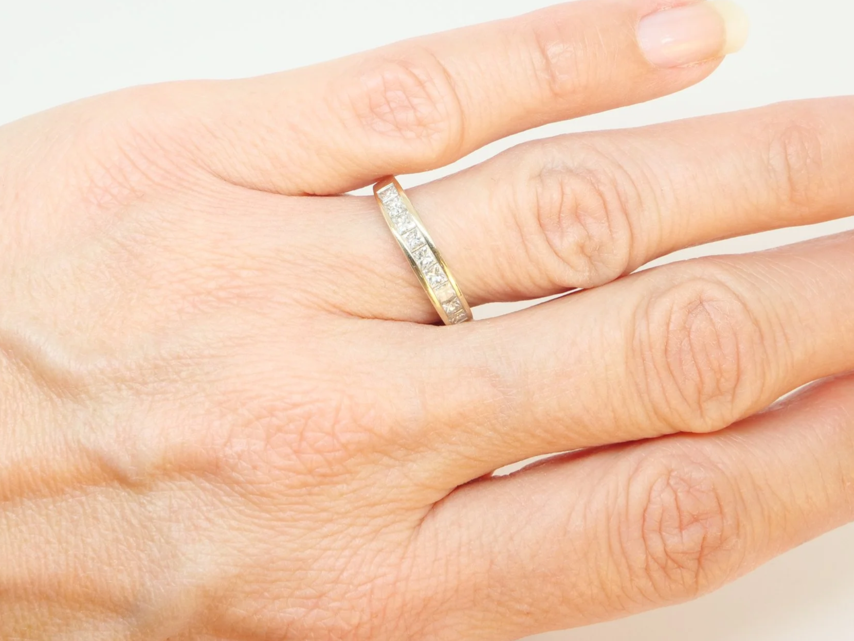 Lovely 18ct gold princess cut diamond half eternity ring, set with nine princess cut diamonds. Total diamond weight  0.77ct (stamped on band).