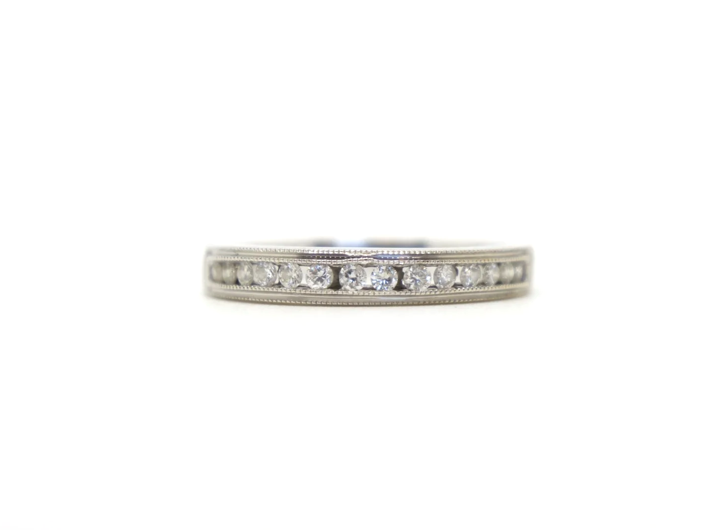 Beautiful 18ct white gold diamond half eternity ring, channel set with a row of brilliant cut diamonds across the front of the band, totalling 0.25ct.