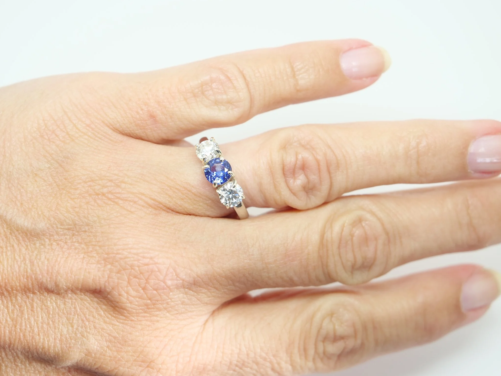 Platinum sapphire and diamond three stone ring, round cut sapphire centre 1.8ct