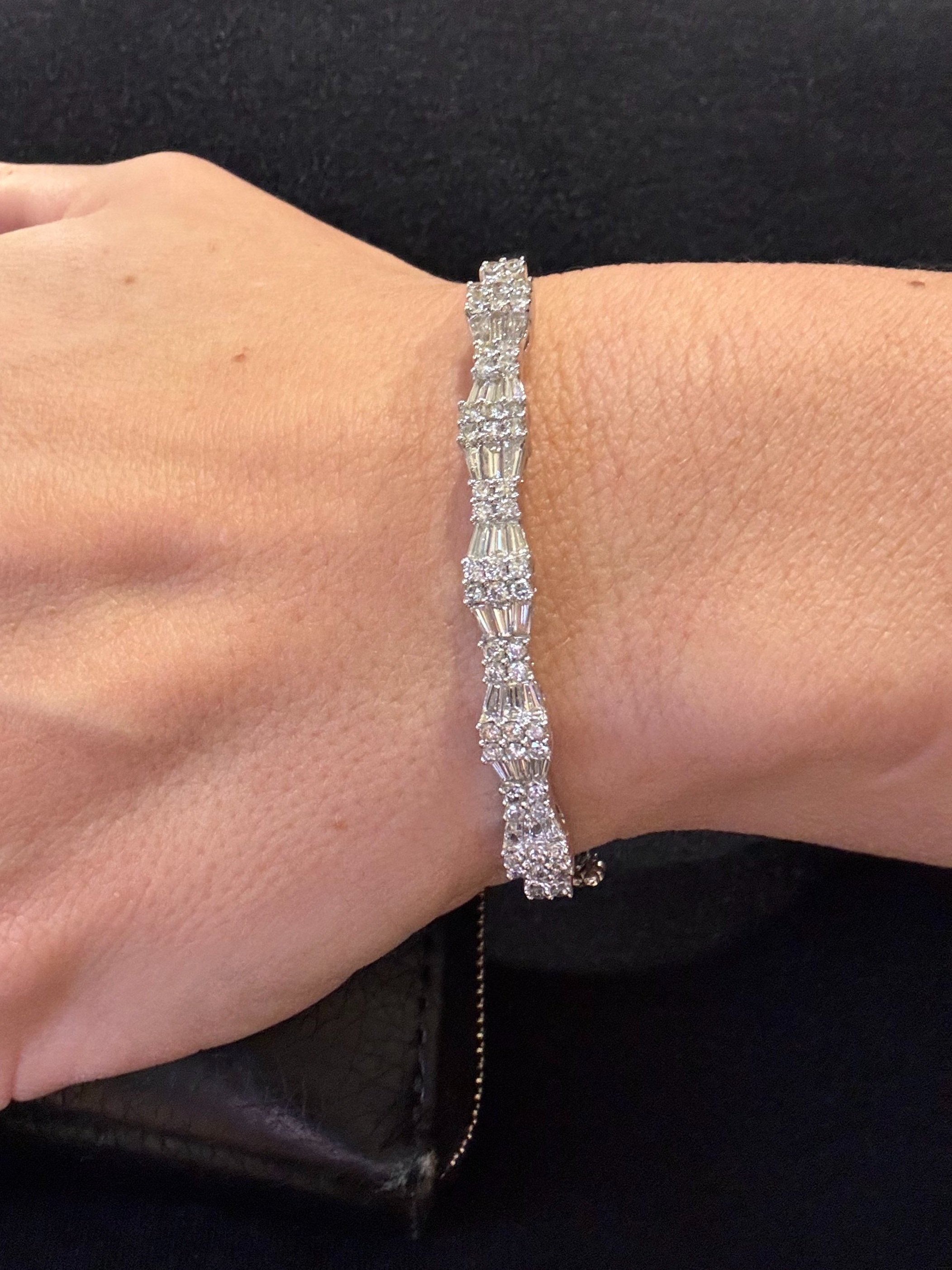Show stopping contemporary 14ct white gold bangle, set with approximately 2.5cts of brilliant cut and baguette cut diamonds in this fabulous geometric design.