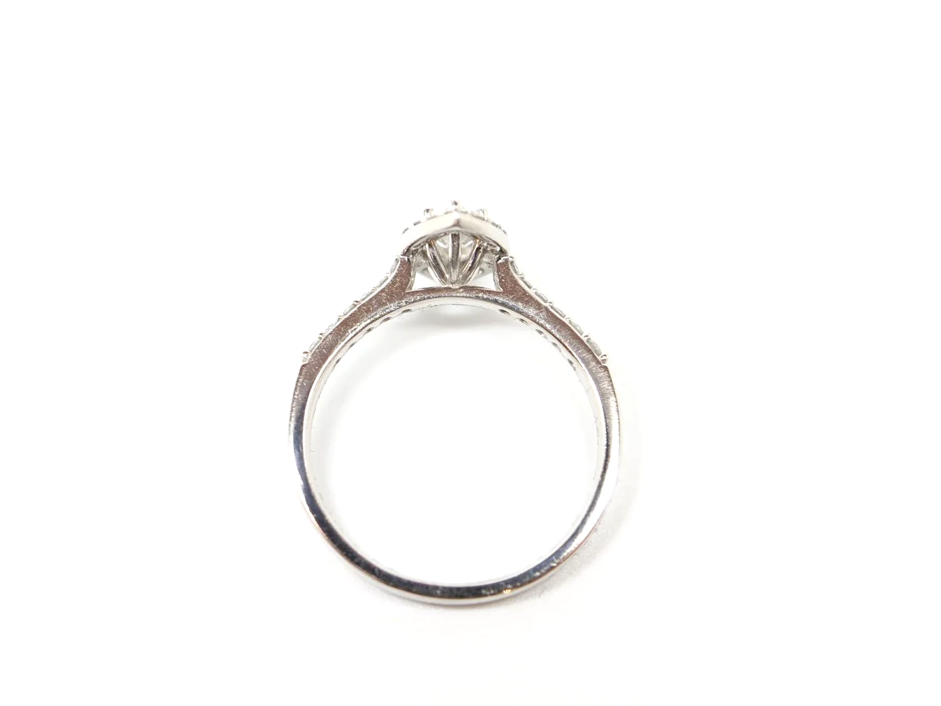 platinum diamond halo ring set with a marquise-cut diamond at the centre, surrounded by a pavé-set halo
