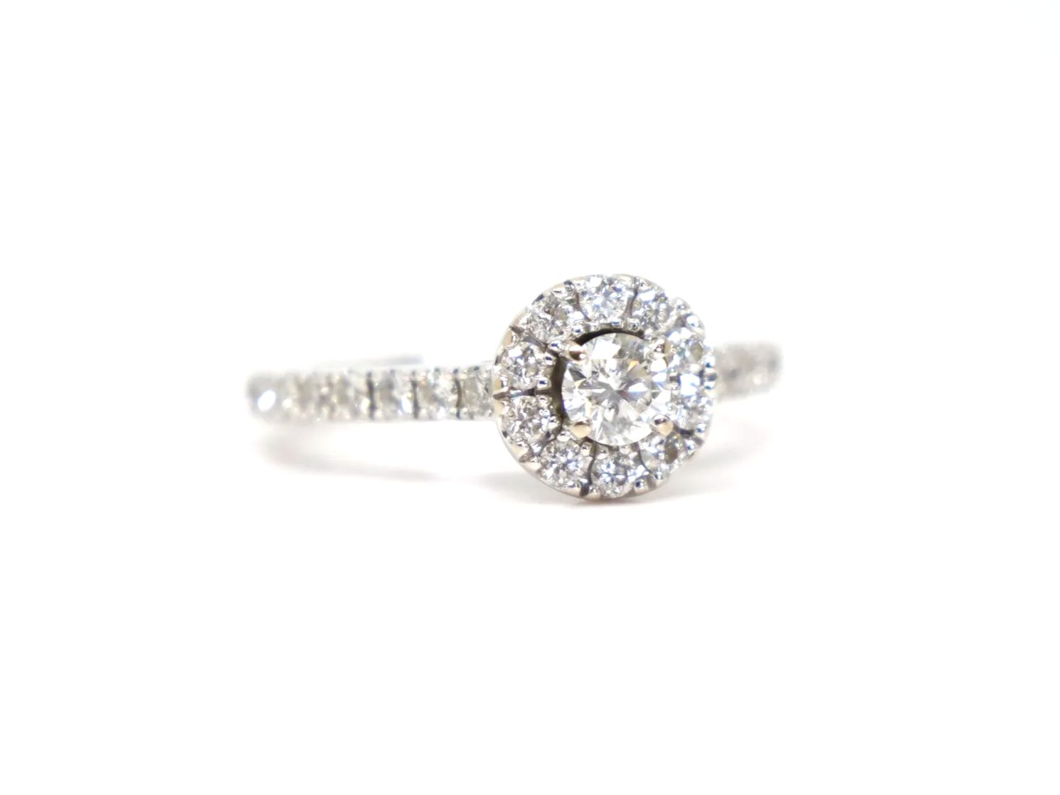 14ct white gold diamond halo ring set with a round brilliant cut diamond at the centre surrounded by a pavé-set halo of smaller diamonds