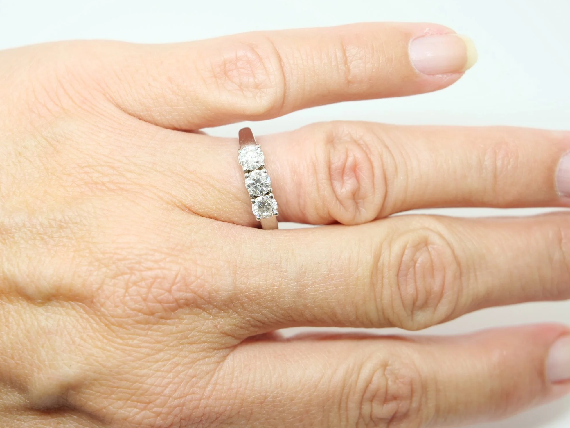 Platinum diamond three stone ring, round brilliant cut diamonds