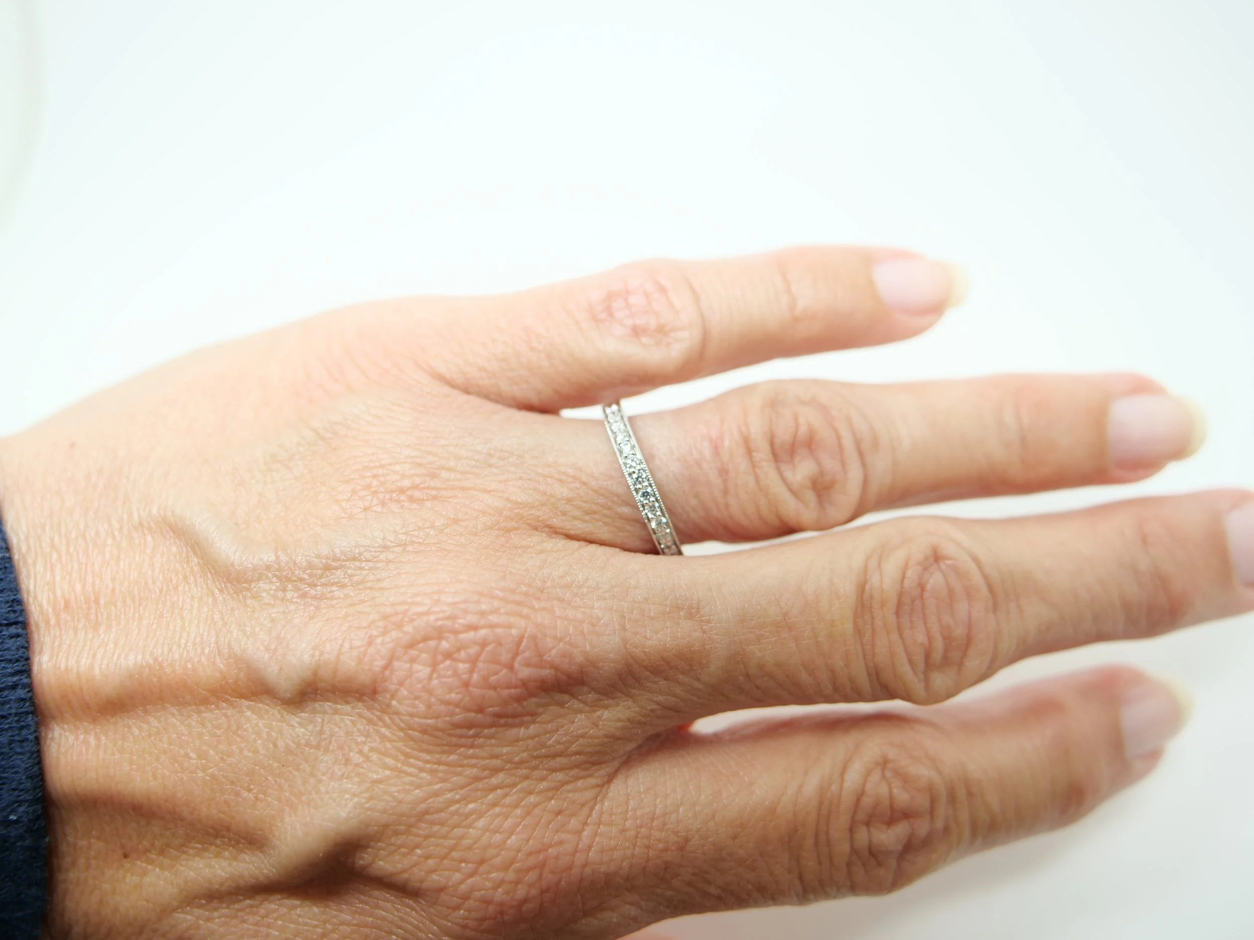 pretty platinum diamond half-eternity ring set with round brilliant-cut diamonds