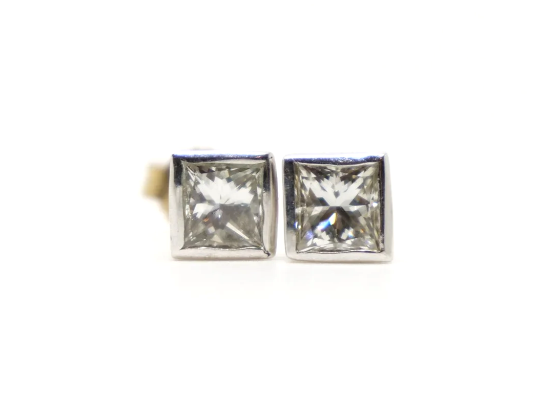 Very pretty 18ct gold princess cut diamond stud earrings in a lovely rubover setting. Each princess cut diamond is approximately 0.39ct, with a total combined weight of approximately 0.78ct.