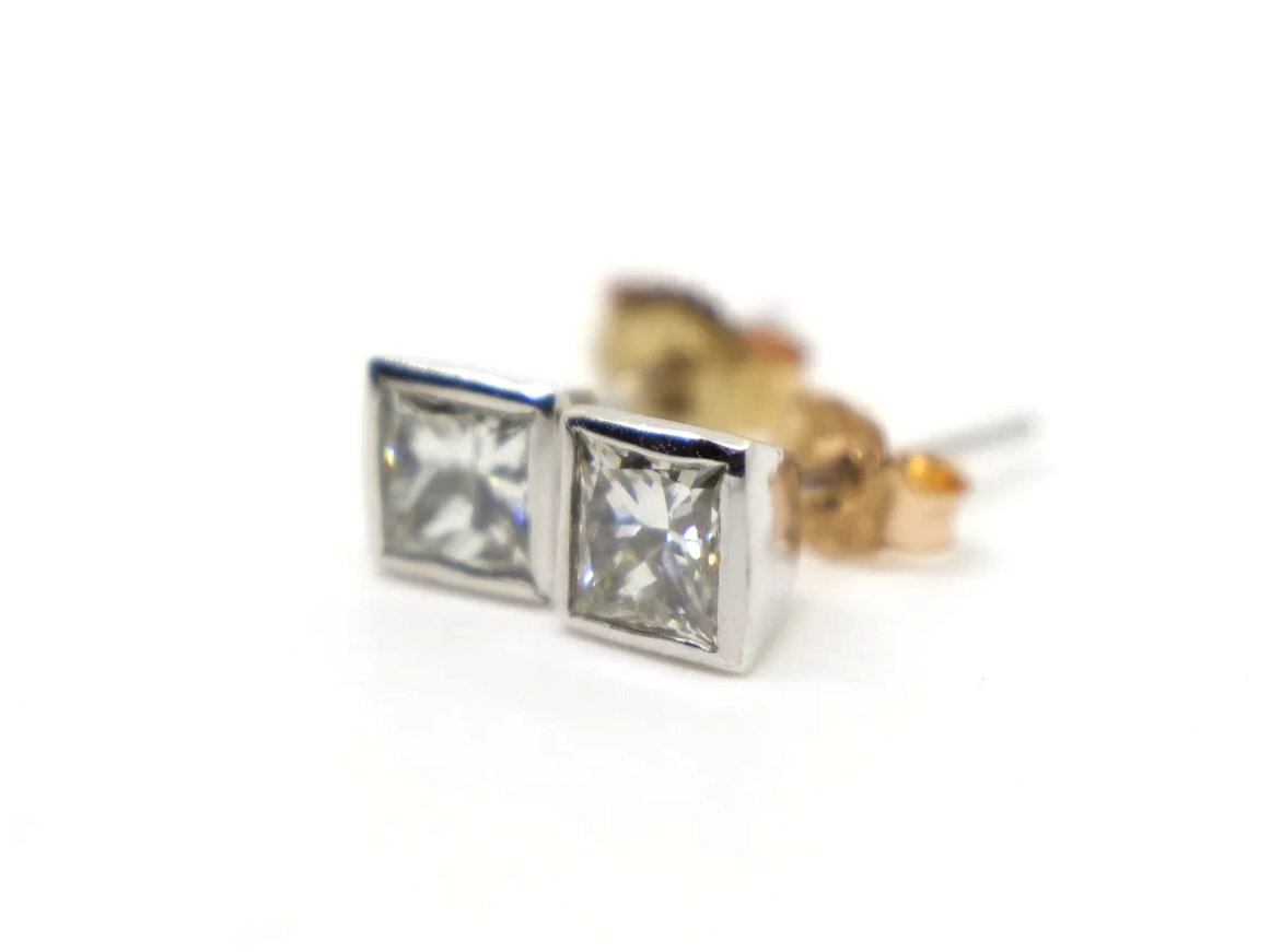 Very pretty 18ct gold princess cut diamond stud earrings in a lovely rubover setting. Each princess cut diamond is approximately 0.39ct, with a total combined weight of approximately 0.78ct.
