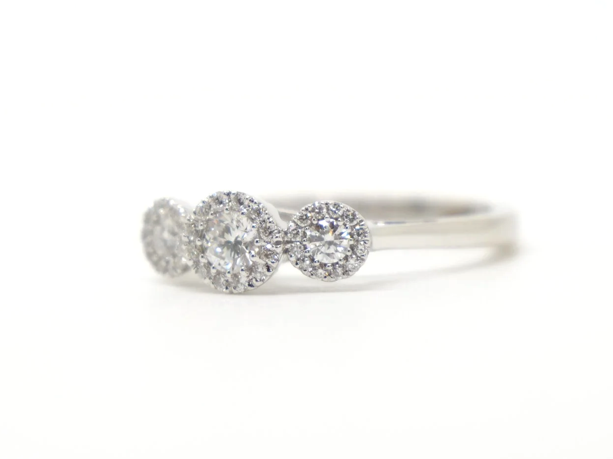 Contemporary 18ct gold diamond ring in a very pretty triple halo three stone design. Approximately 0.5cts diamonds total.
