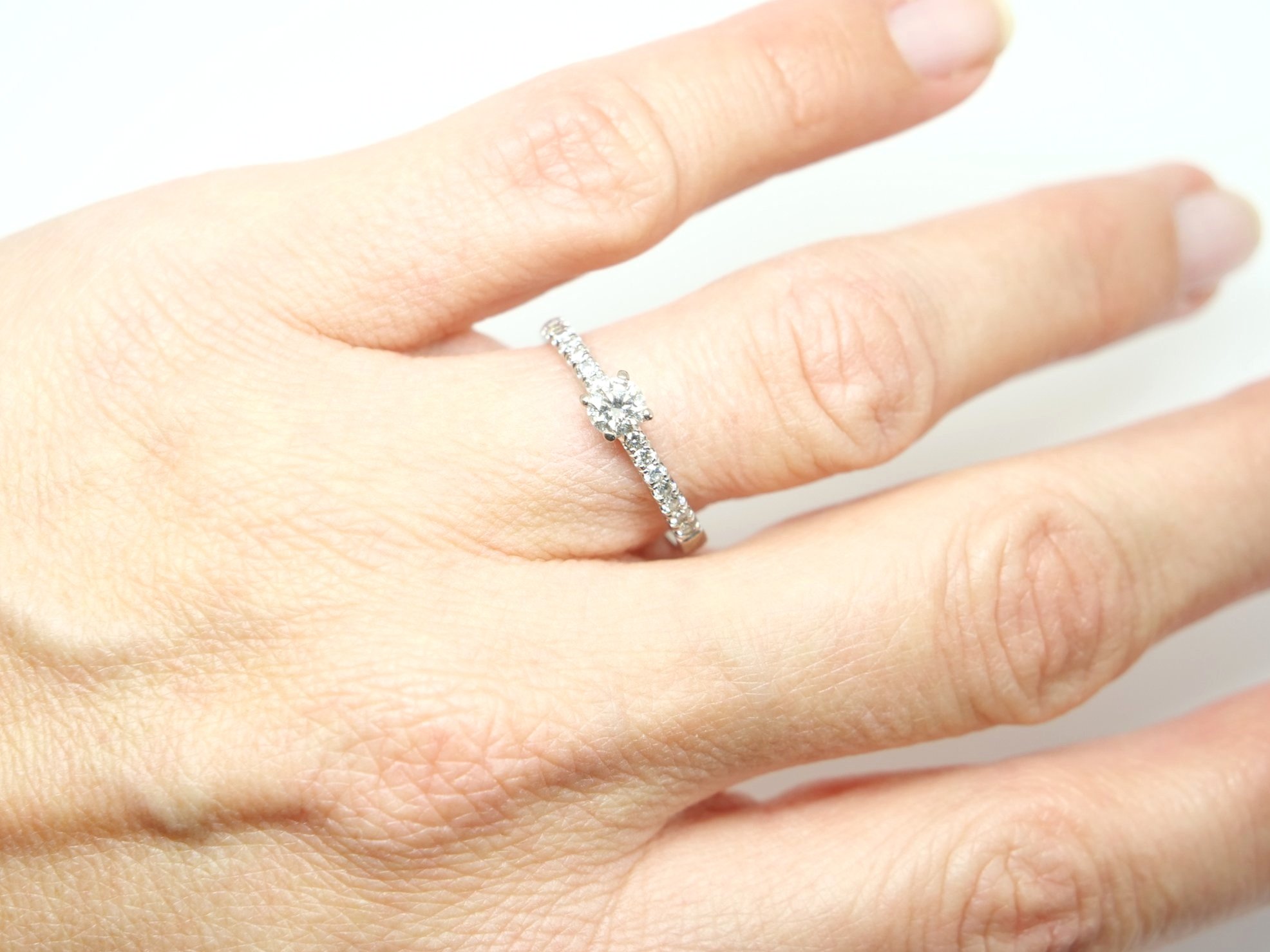Contemporary 18ct gold diamond solitaire in this wonderful classic style. Central brilliant cut diamond of approximately 0.36cts, with further diamonds to shoulders.
