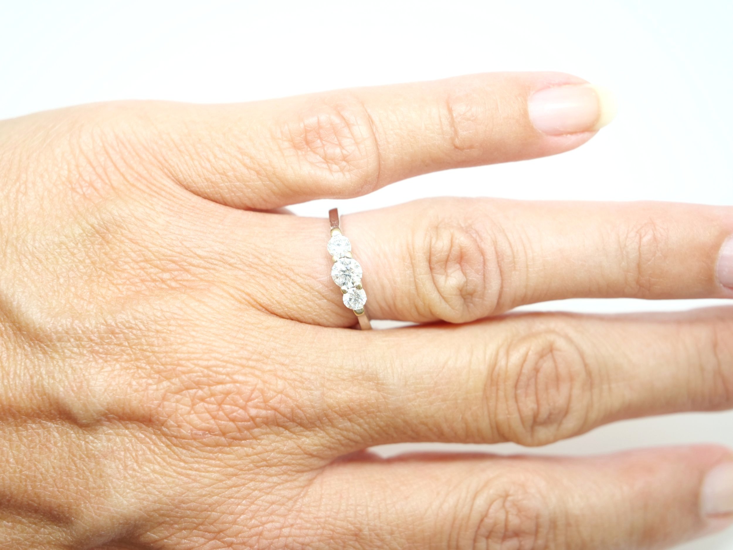 Stunning 18ct gold vintage diamond trilogy ring, set with three brilliant cut diamonds in an unusual elegant design. Approximately 0.7cts in total.