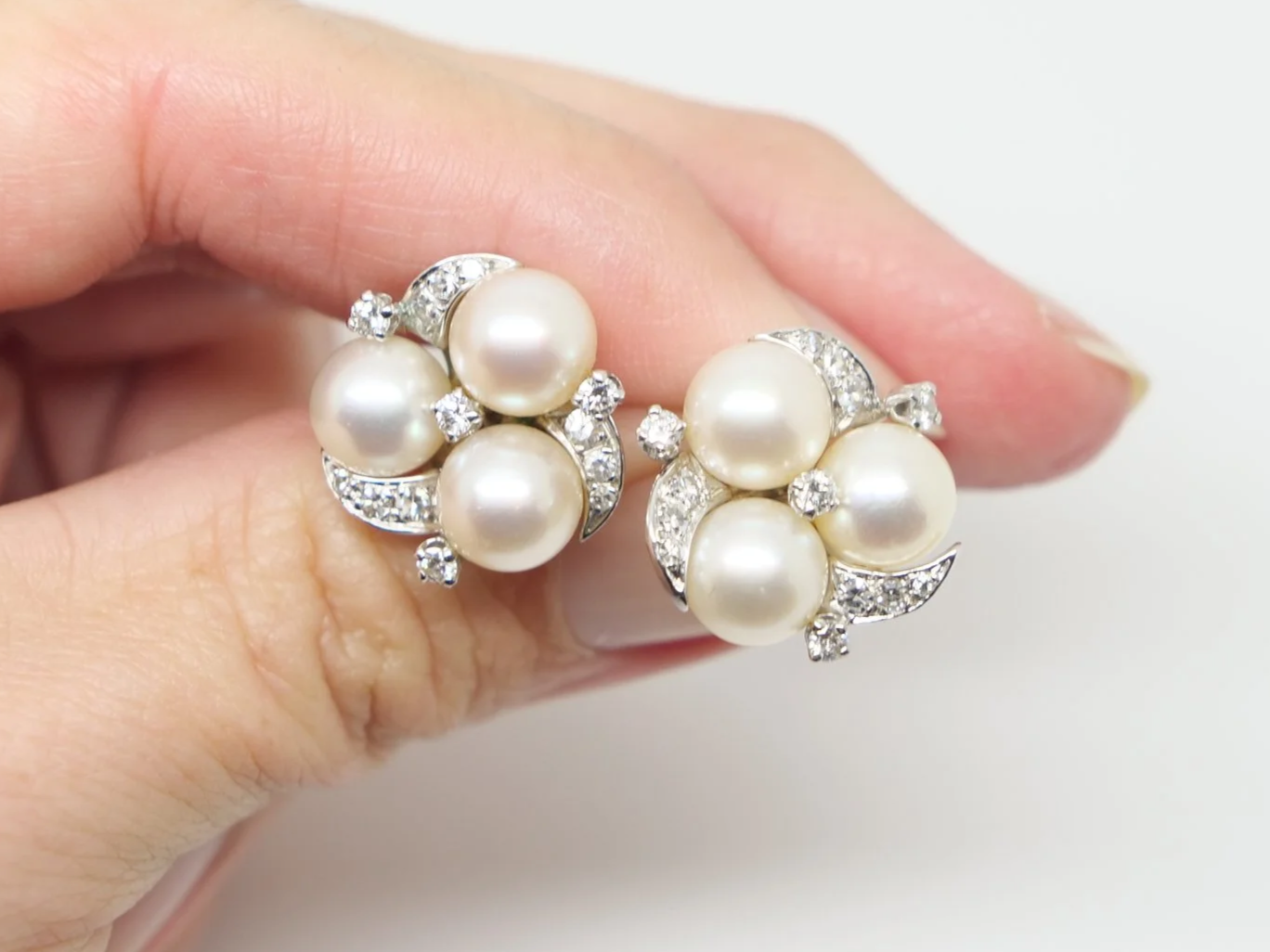 Lovely vintage pearl and diamond earrings in 14ct gold, each set with three pearls with diamonds in a lovely floral design.