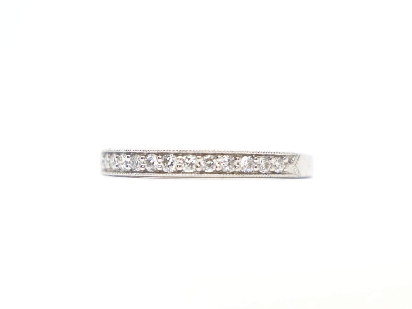 pretty platinum diamond half-eternity ring set with round brilliant-cut diamonds