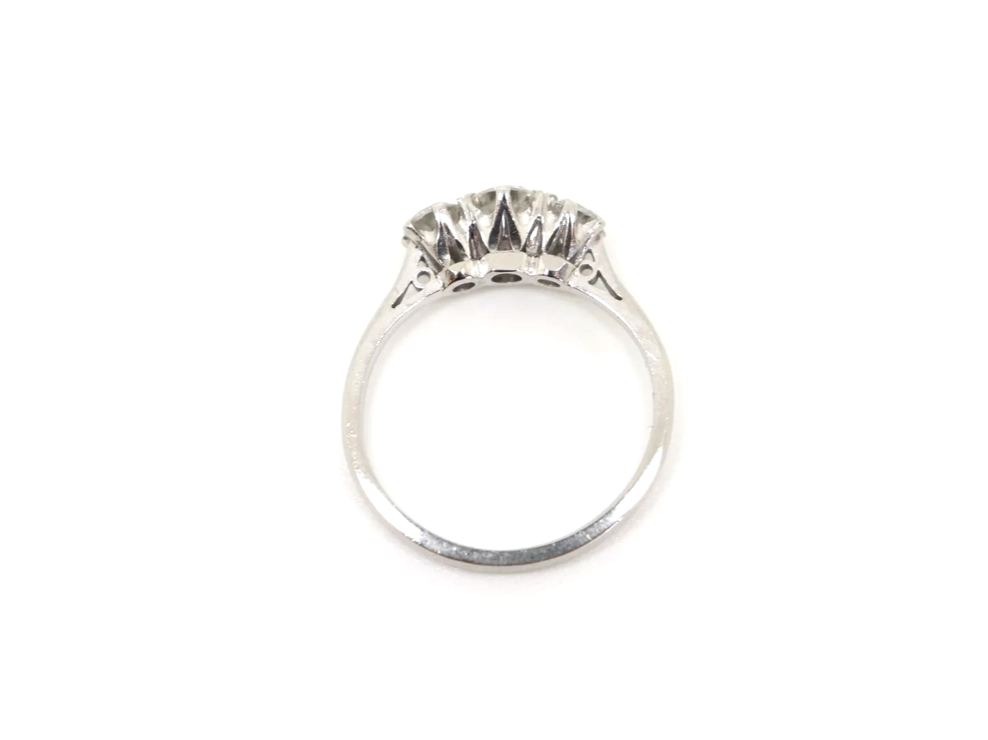Classic platinum and diamond three stone ring, set with a larger central diamond, with a smaller diamond to each side. Approximately 0.85ct total diamonds.