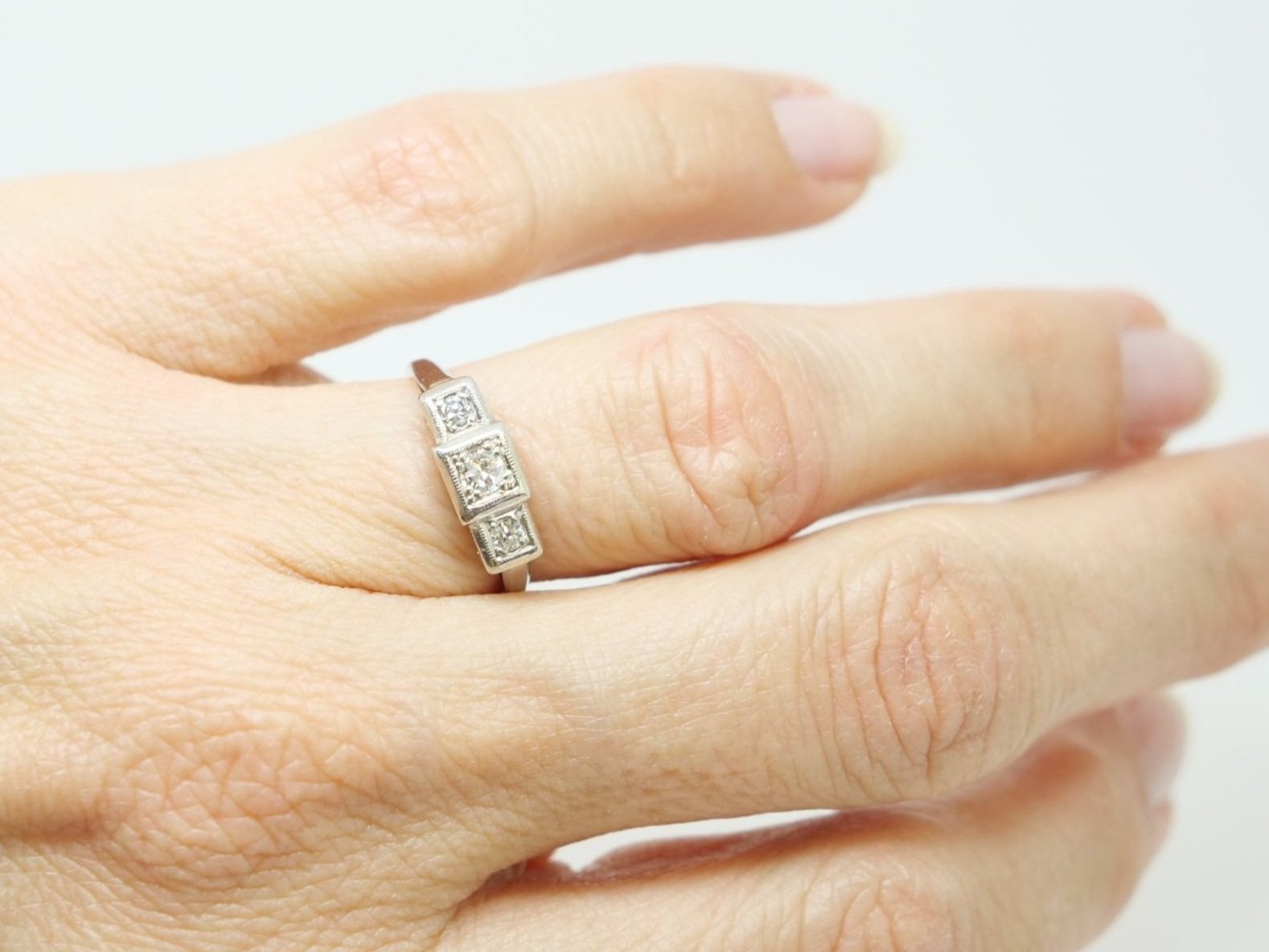 Art Deco diamond three stone ring in 18ct gold and platinum, set with three old cut diamonds in this unusual square shape design.