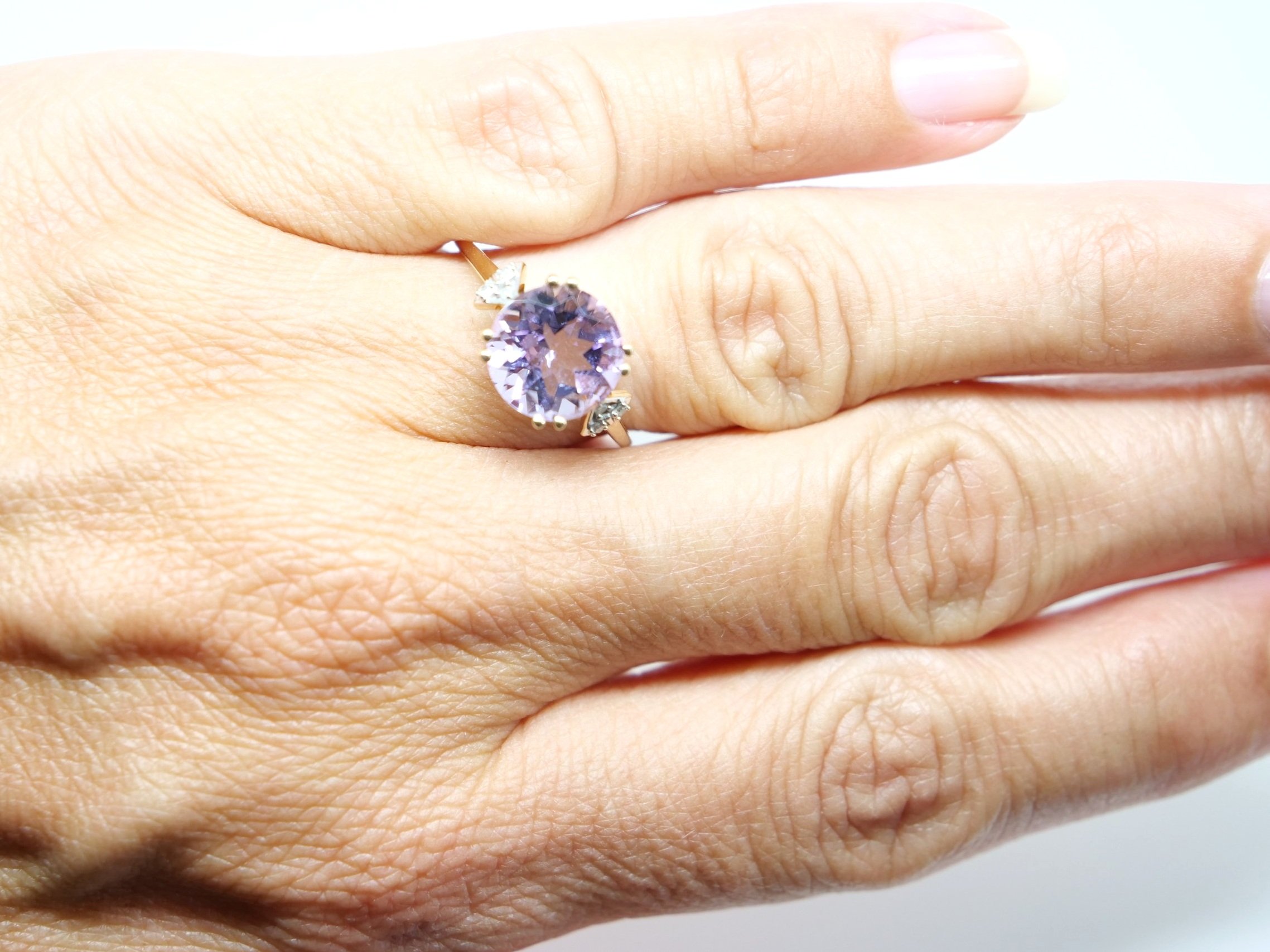 Very pretty 9ct gold vintage cocktail ring, set with a large round cut amethyst in a delightful Rose de France pink. With three small diamonds to each side.