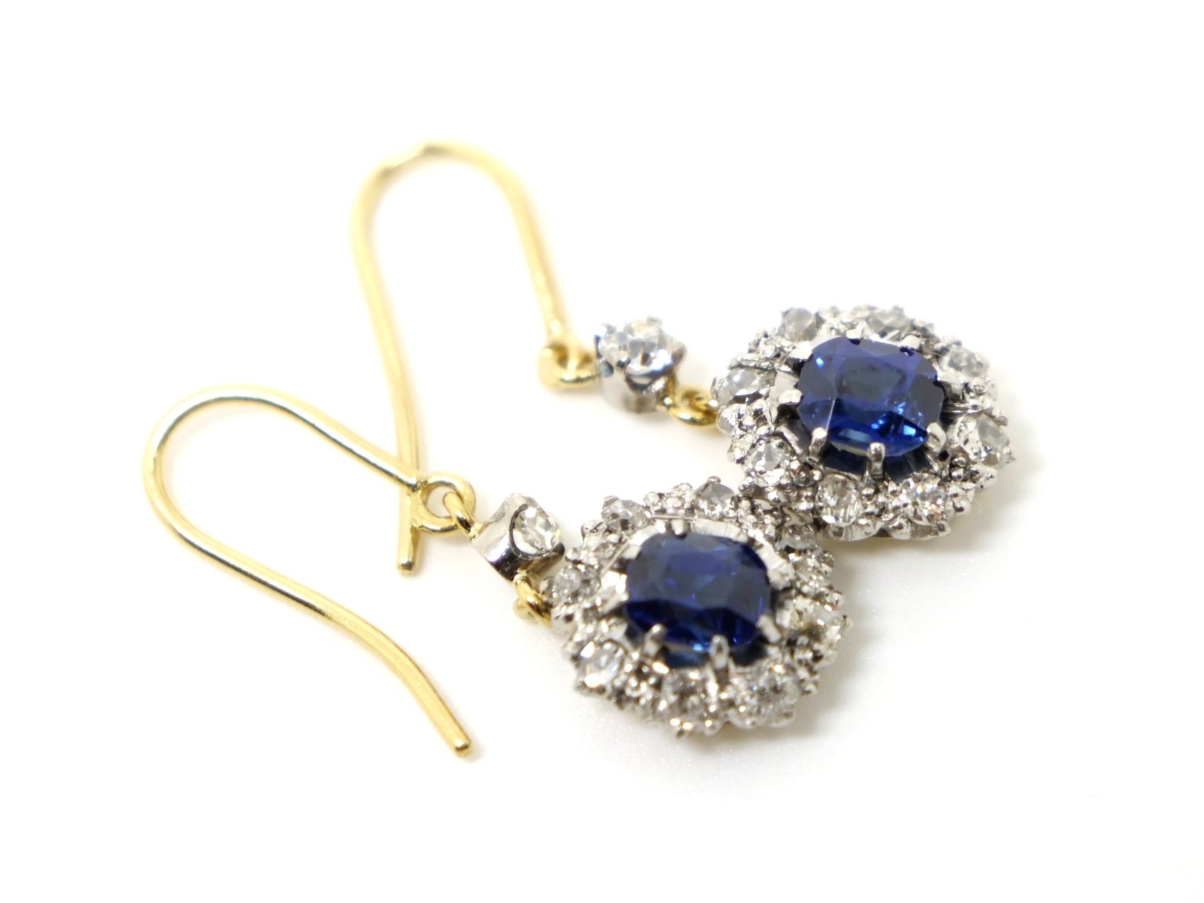 vintage drop earrings in 18ct gold, each set with a beautiful oval cut blue sapphire and surrounded by old cut diamonds.