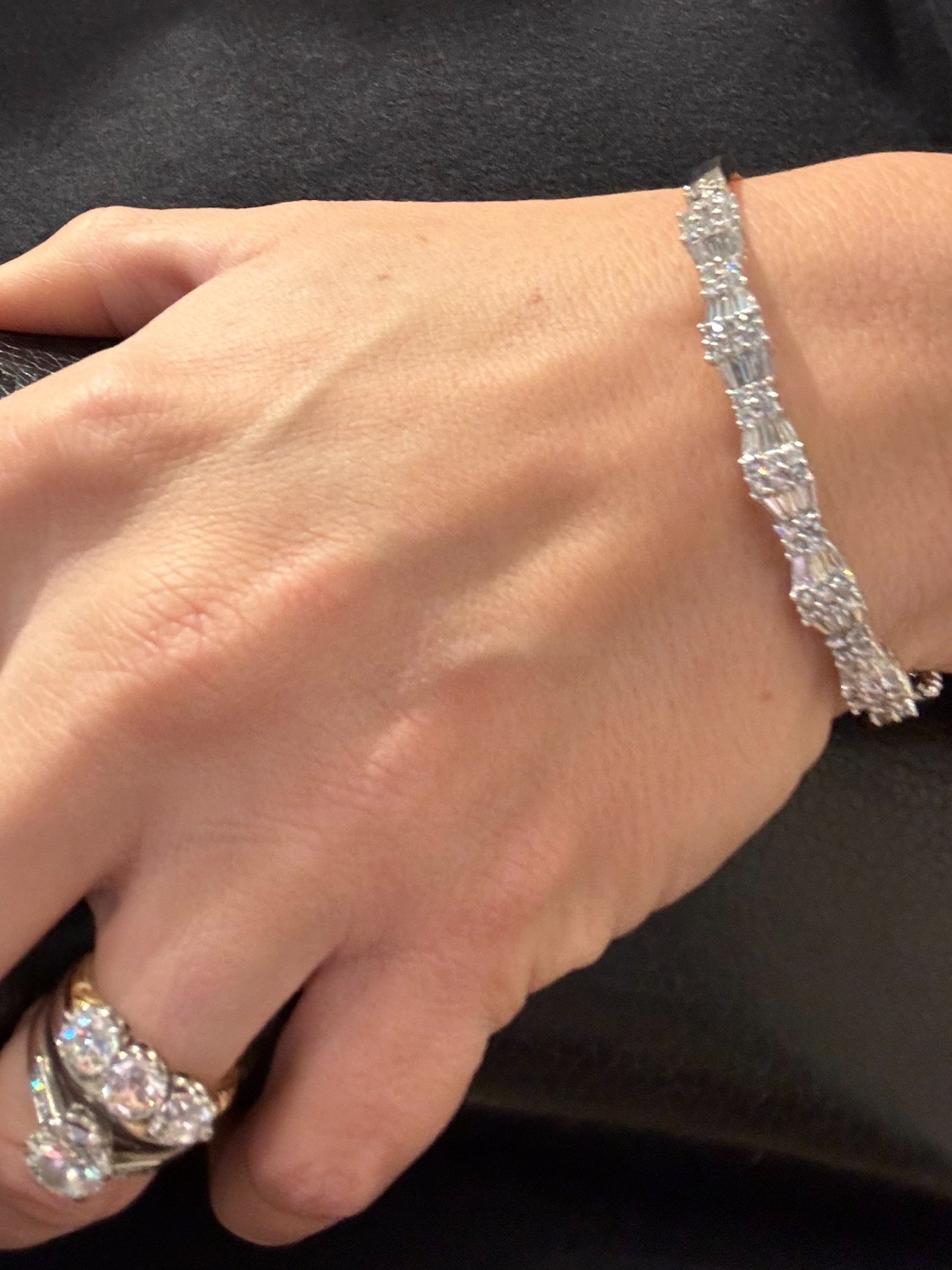 Show stopping contemporary 14ct white gold bangle, set with approximately 2.5cts of brilliant cut and baguette cut diamonds in this fabulous geometric design.