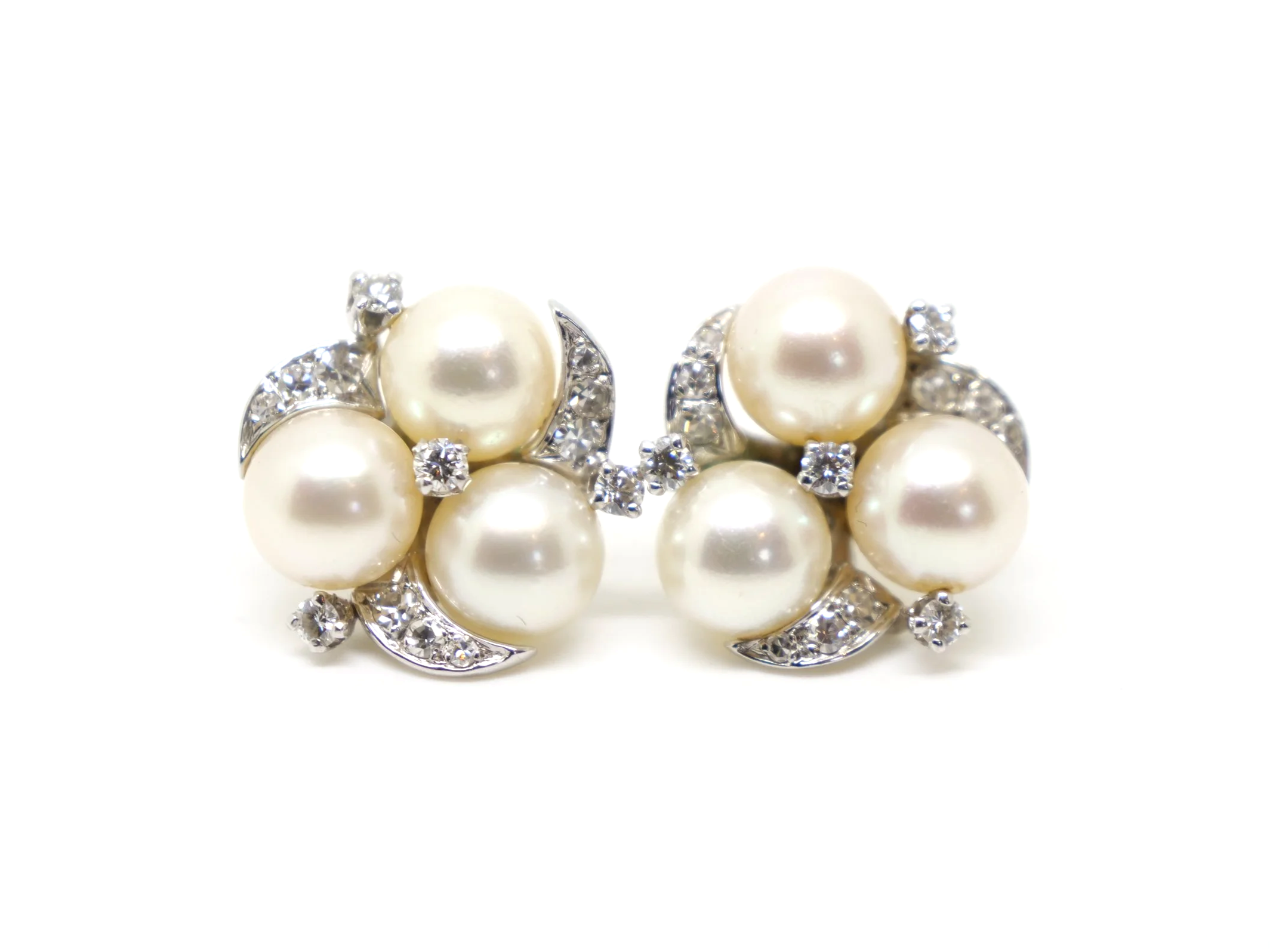 Lovely vintage pearl and diamond earrings in 14ct gold, each set with three pearls with diamonds in a lovely floral design.