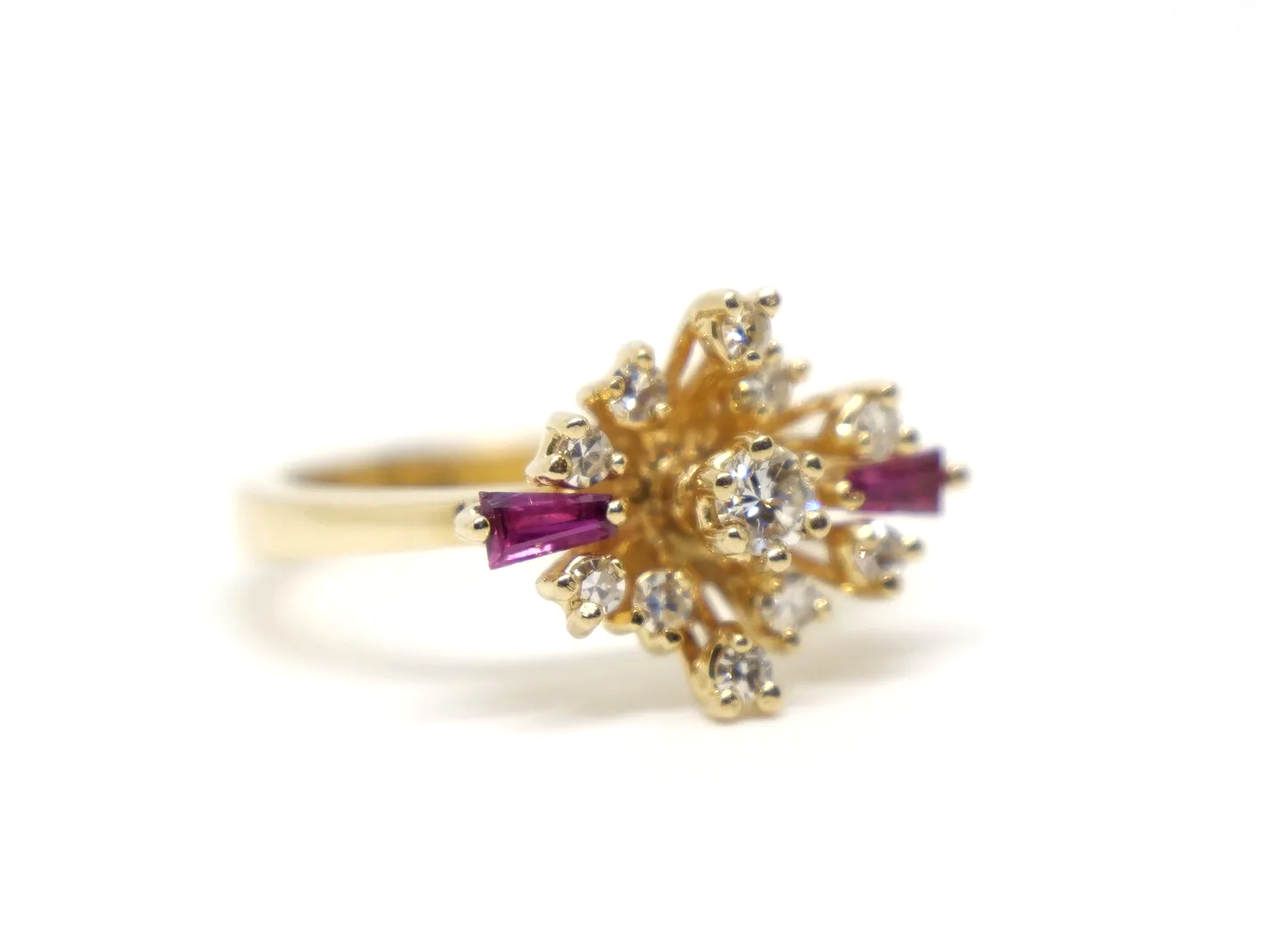 Unusual vintage 14ct gold ruby and diamond spray design ring, with a diamond centre and further diamonds in this east west marquise design. Highlighted with two tapered baguette cut rubies.