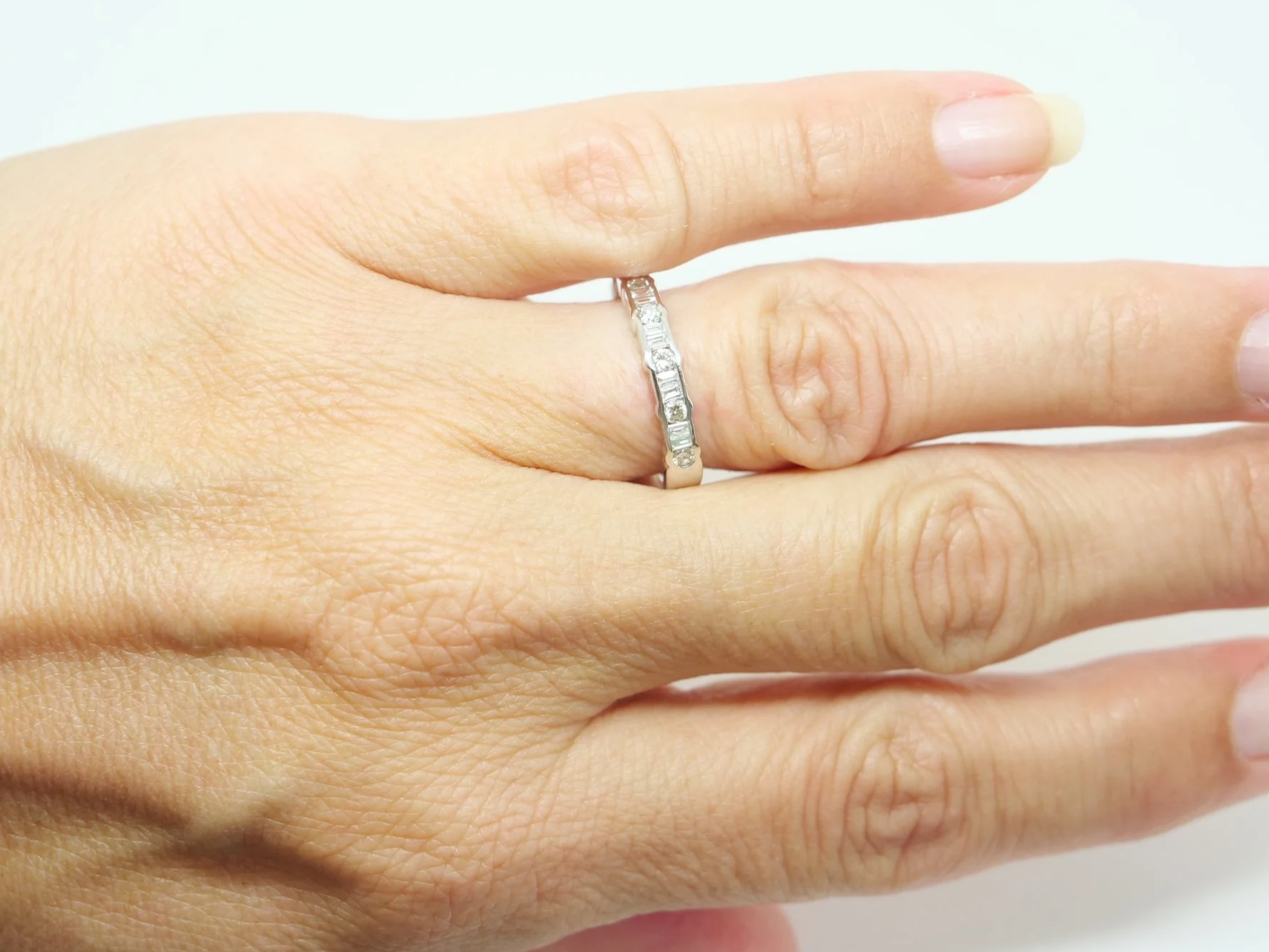 18ct white gold half eternity ring with alternating round and baguette cut diamonds