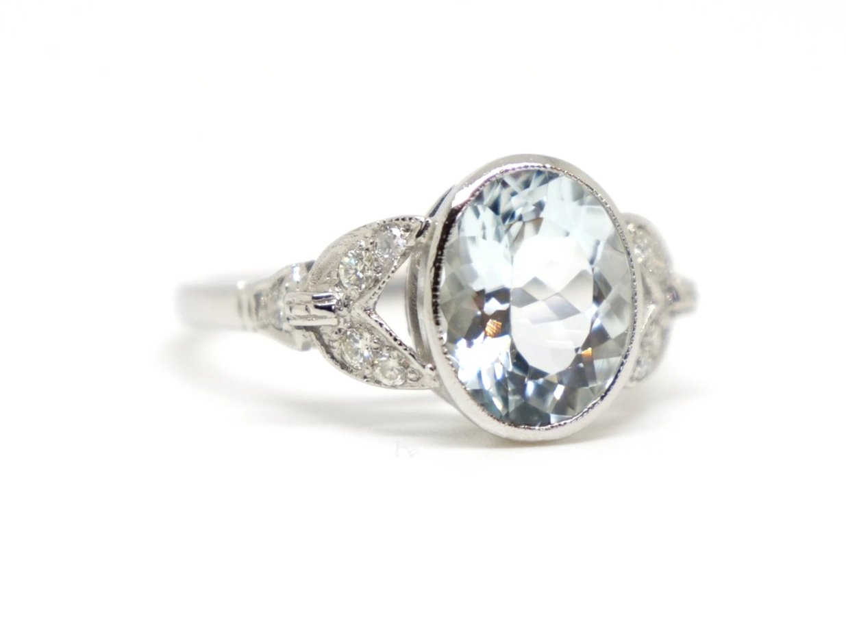 Super vintage style oval cut aquamarine and diamond ring in platinum, set with a 2.25ct oval cut aquamarine with diamonds set into split shoulders.