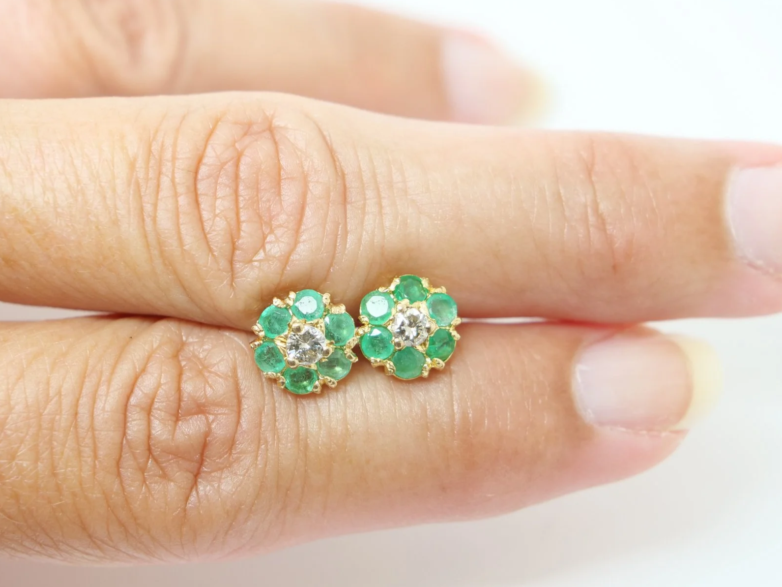 pretty pair of emerald and diamond daisy design vintage earrings in 9ct yellow gold, dating from 1975