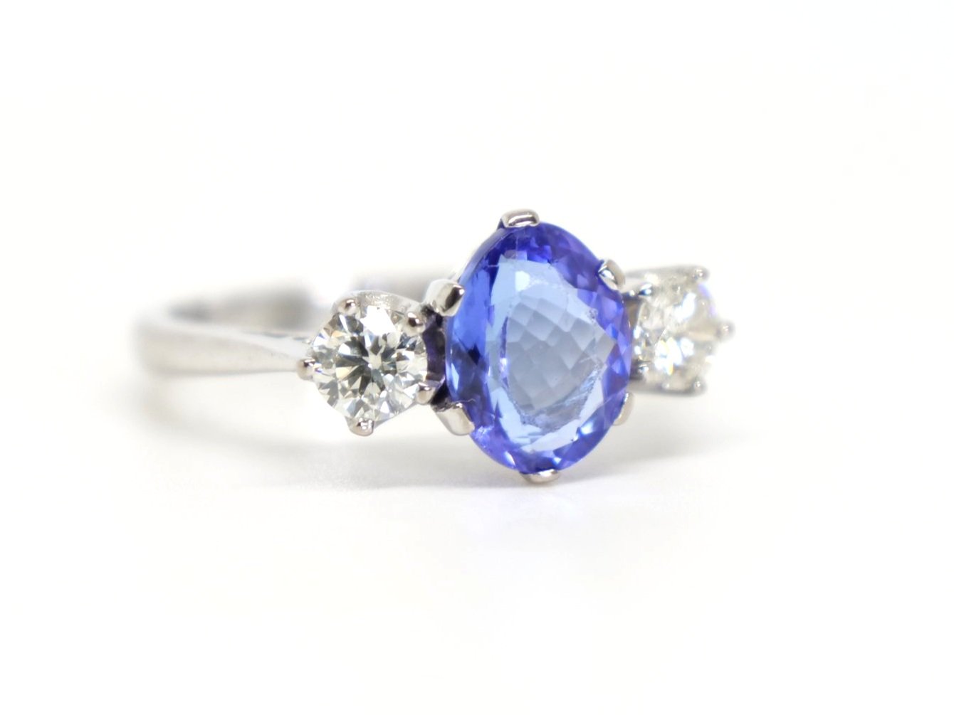 Super vintage 18ct gold oval cut tanzanite and diamond three stone ring, set with a 1.7ct oval cut tanzanite with a diamond to each side.