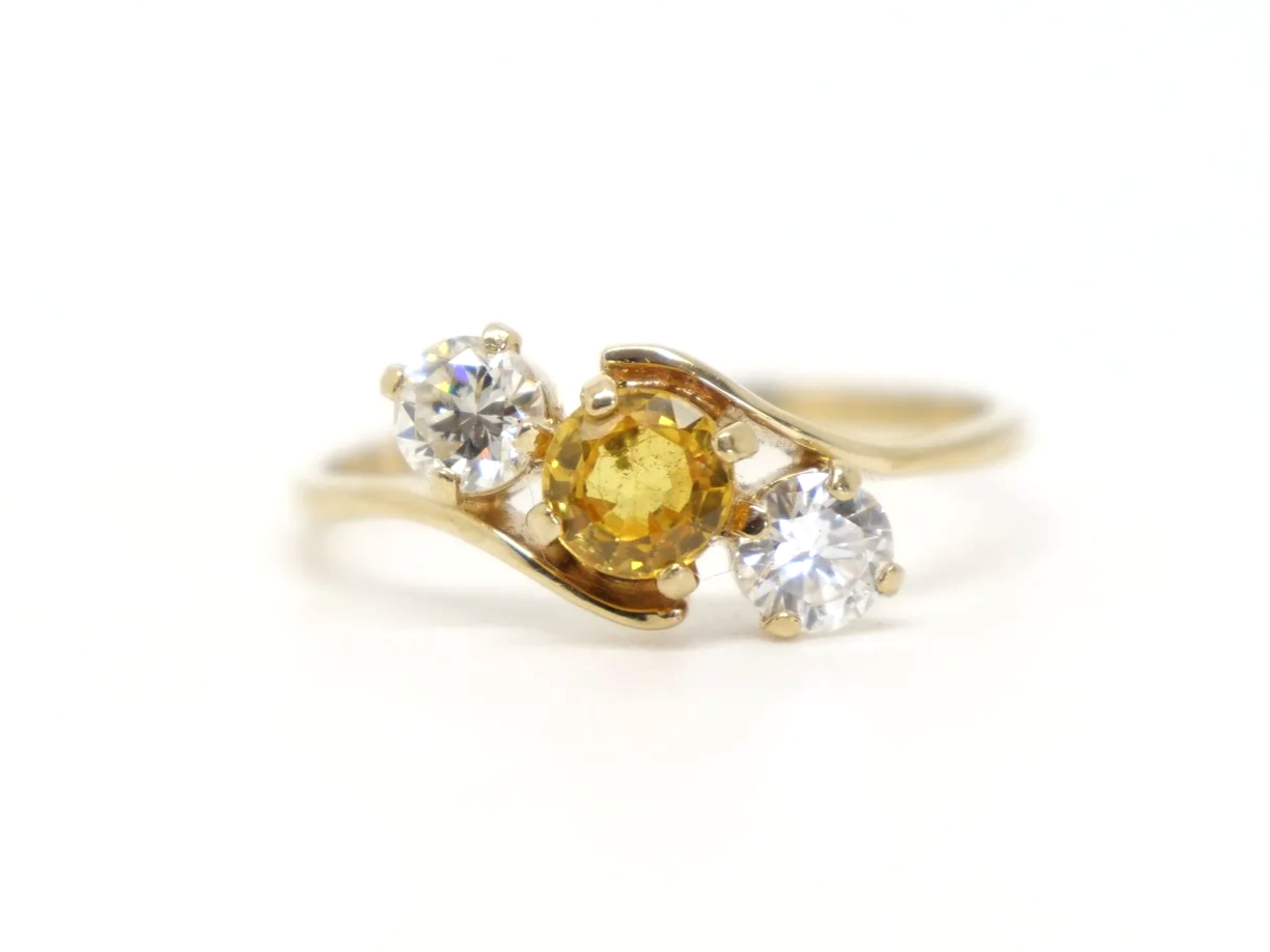 Lovely 14ct gold vintage twist design ring set with a yellow sapphire and two brilliant cut diamonds.
