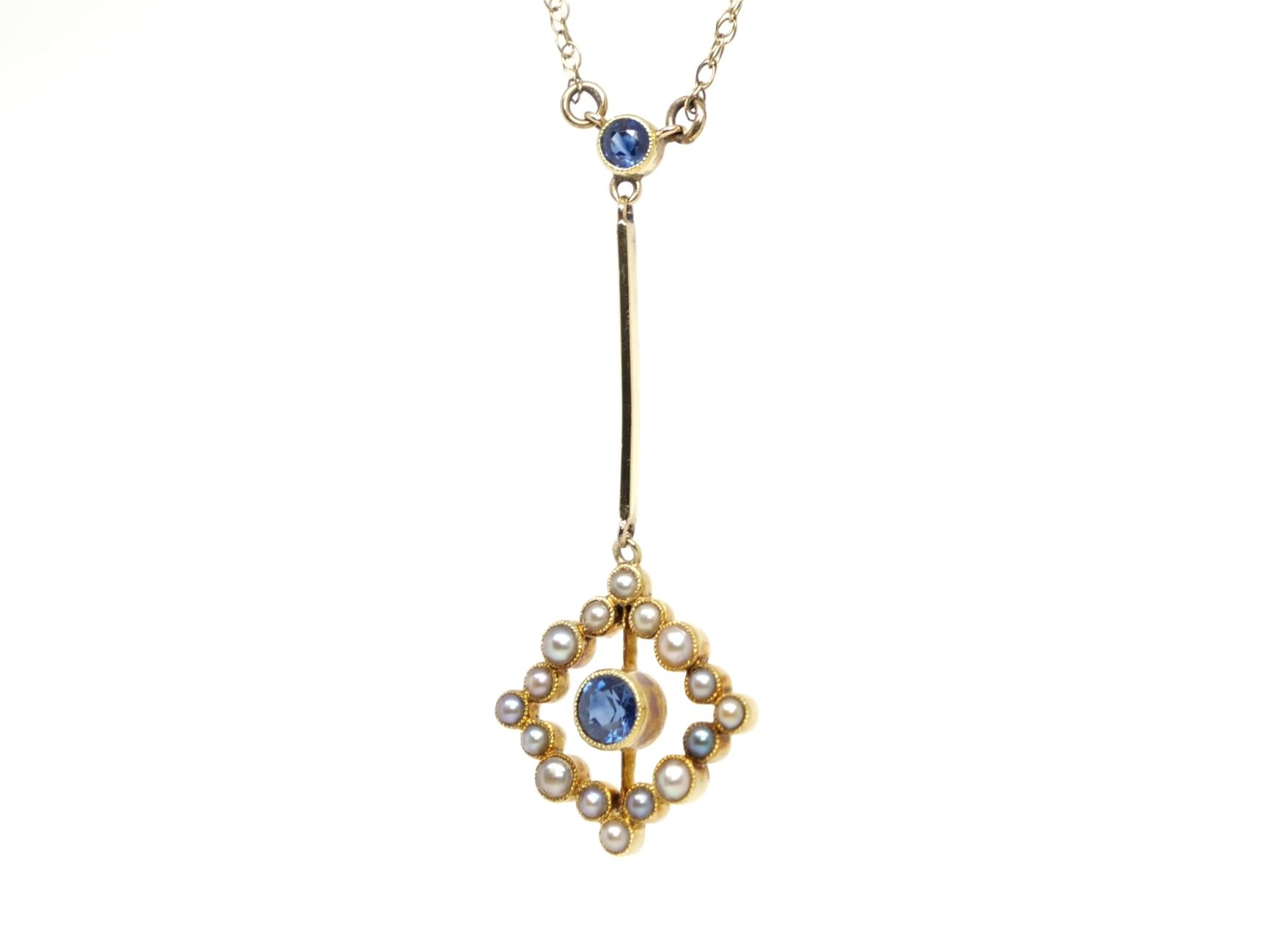 Very pretty vintage 18ct gold sapphire and pearl pendant, set with two round cut sapphires and set with seed pearls. Pendant is 18ct gold, with attached 9ct gold chain.