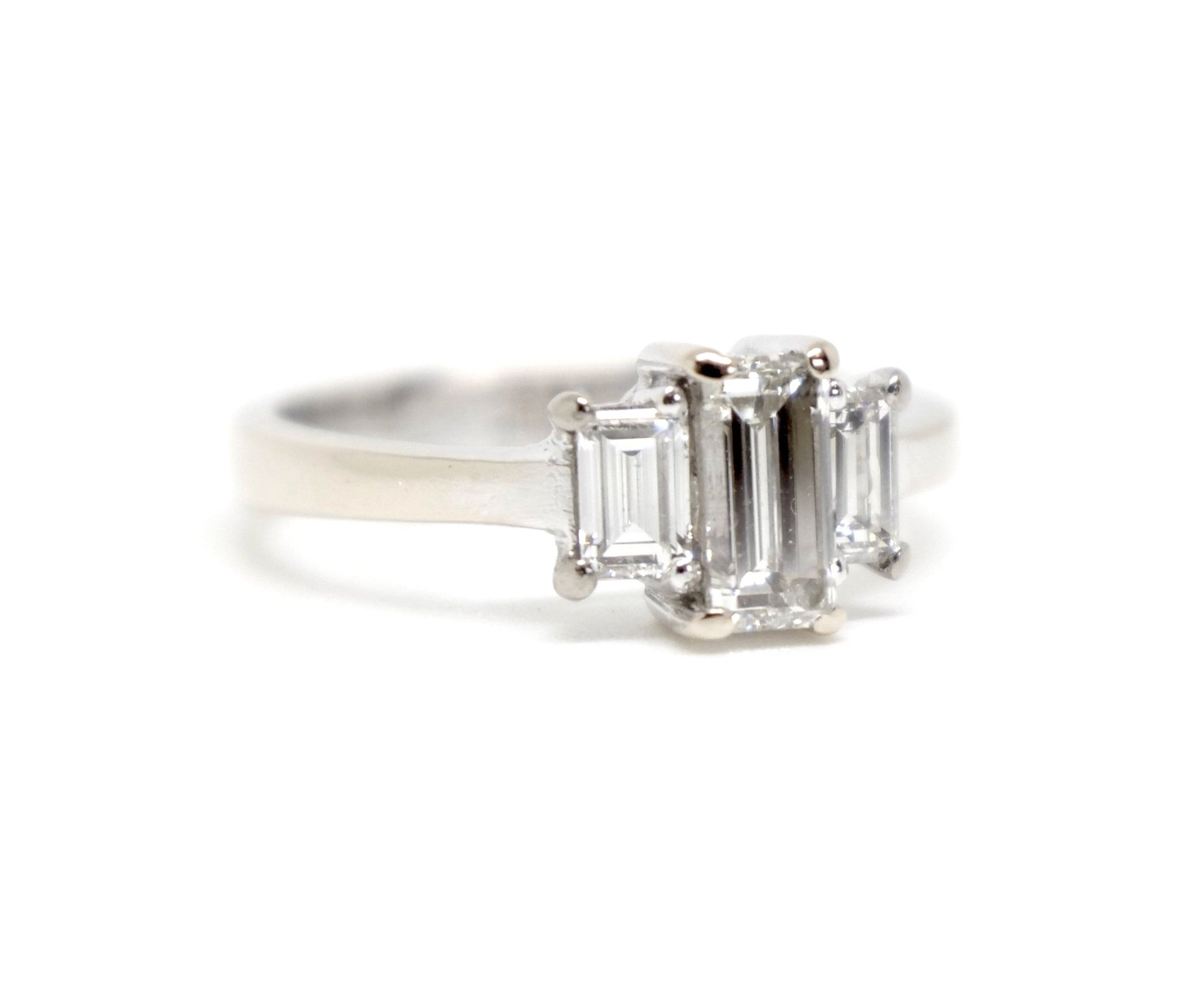 Unusual 18ct gold diamond three stone ring, set with three baguette cut diamonds in this classic and elegant design. Approximately 0.85cts total diamonds.