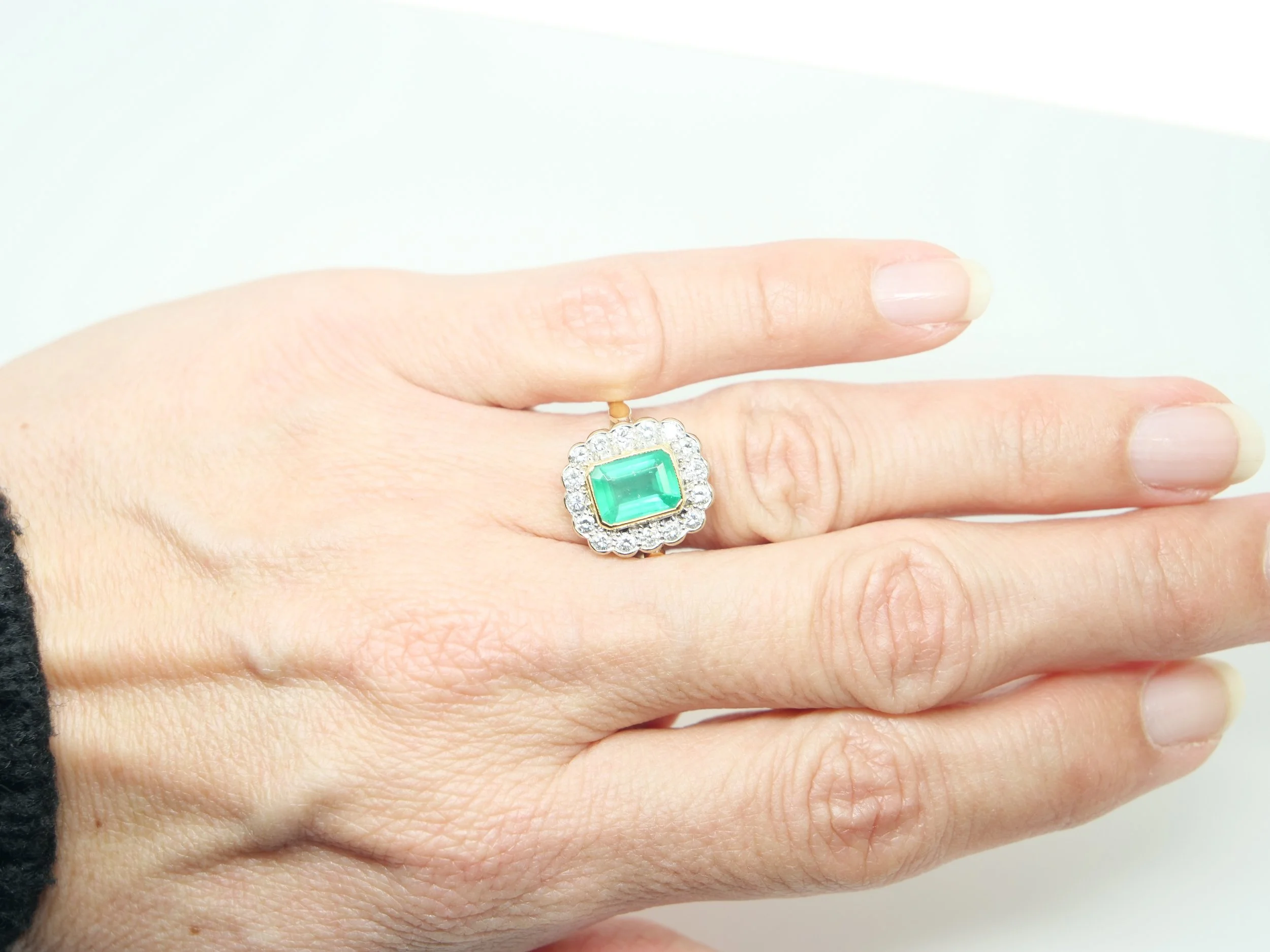 Stunning 18ct gold emerald and diamond ring, set with an emerald cut emerald of approximately 1.6ct, surrounded by brilliant cut diamonds.