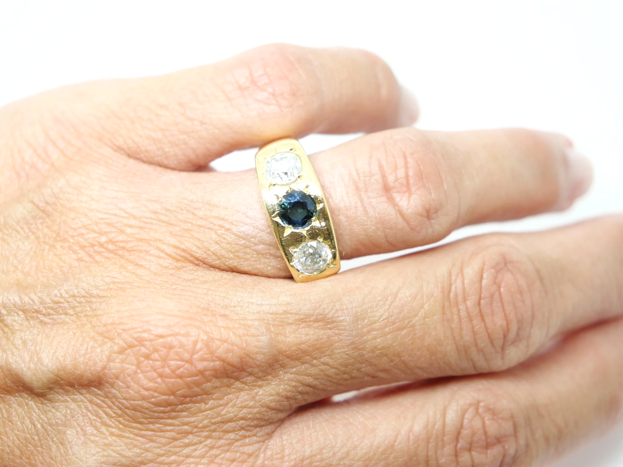 Lovely heavy vintage 18ct gold gypsy ring, set with a round cut sapphire and two brilliant cut diamonds measuring approximately 1ct total.