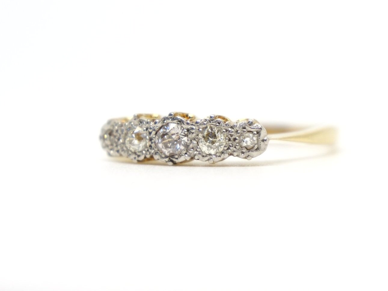 Pretty vintage 18ct gold ring, set with five old cut diamonds. Diamonds have a pretty platinum setting that enhances the appearance and size of the diamonds.