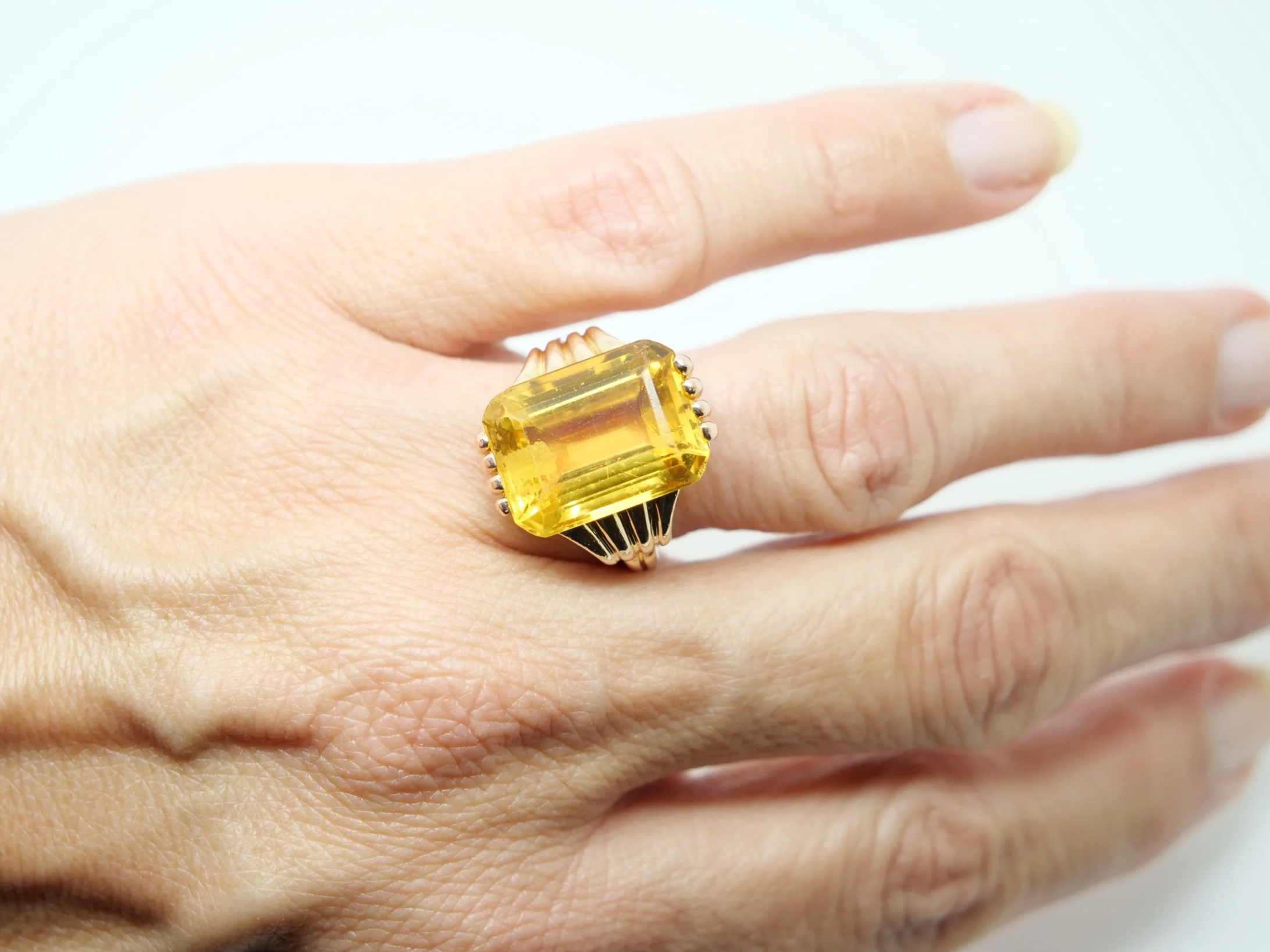 Lovely vintage 18ct gold citrine cocktail ring, set with a large emerald cut citrine and with decorative gold design to each shoulder.