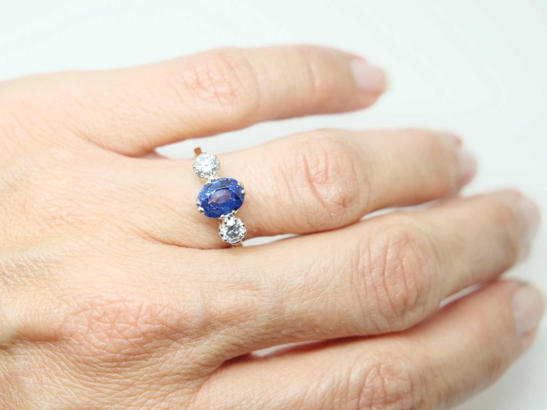 Stunning vintage 18ct gold sapphire and diamond ring, set with an oval cut sapphire with a diamond to each side.
