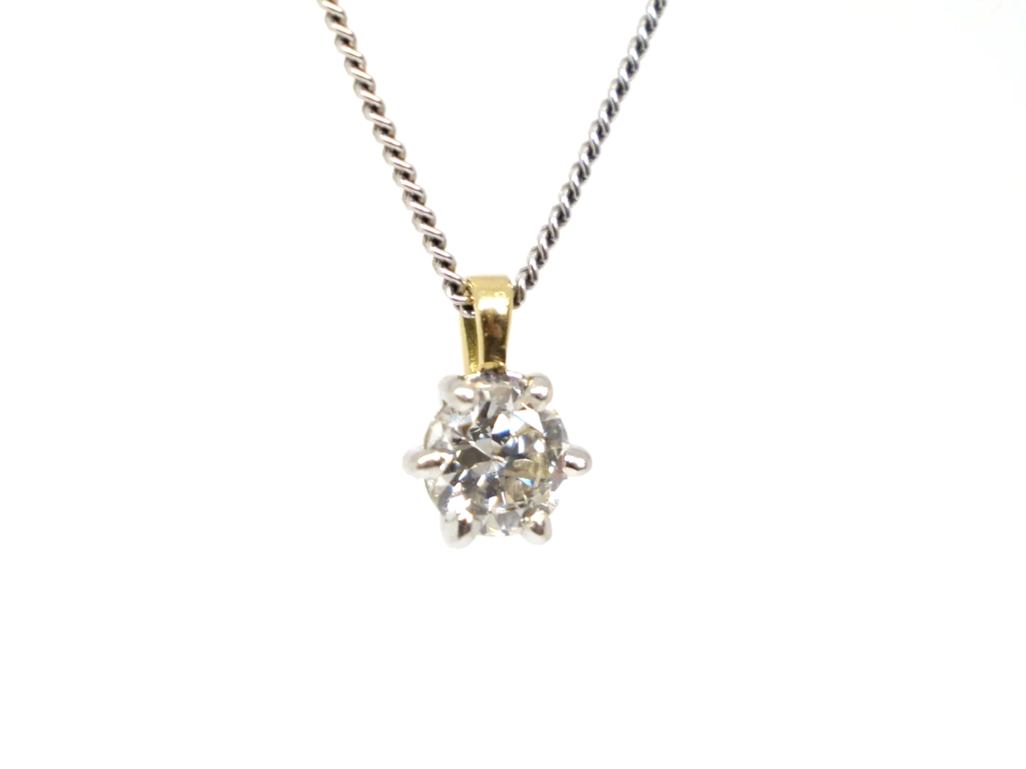 Classic 18ct gold diamond solitaire pendant, set with a very sparkly brilliant cut diamond. Diamond set in white gold with yellow gold bale.
