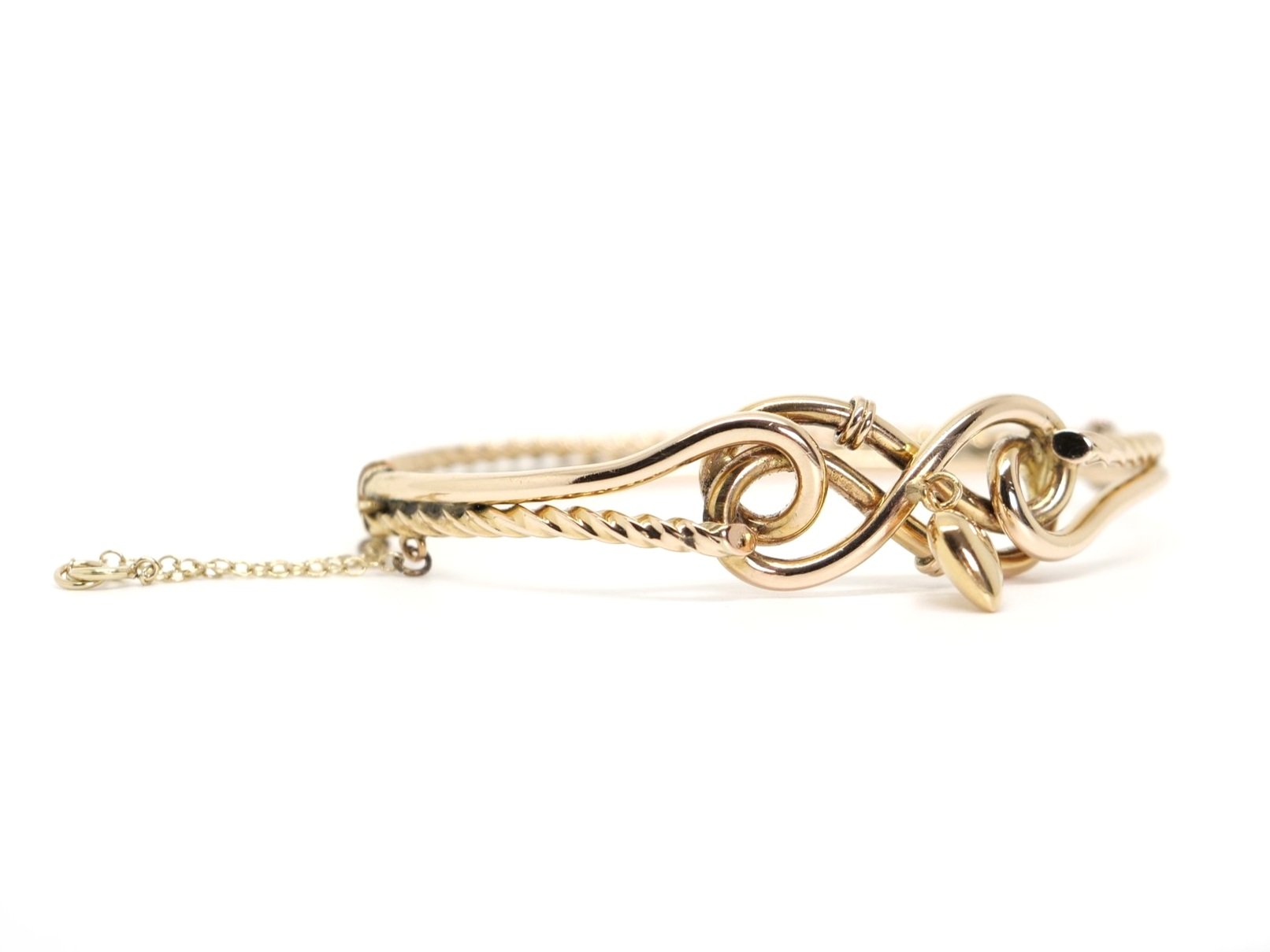 Super vintage bangle in 9ct gold in a wonderful knot style design. Heart charm attached to centre and with safety chain.