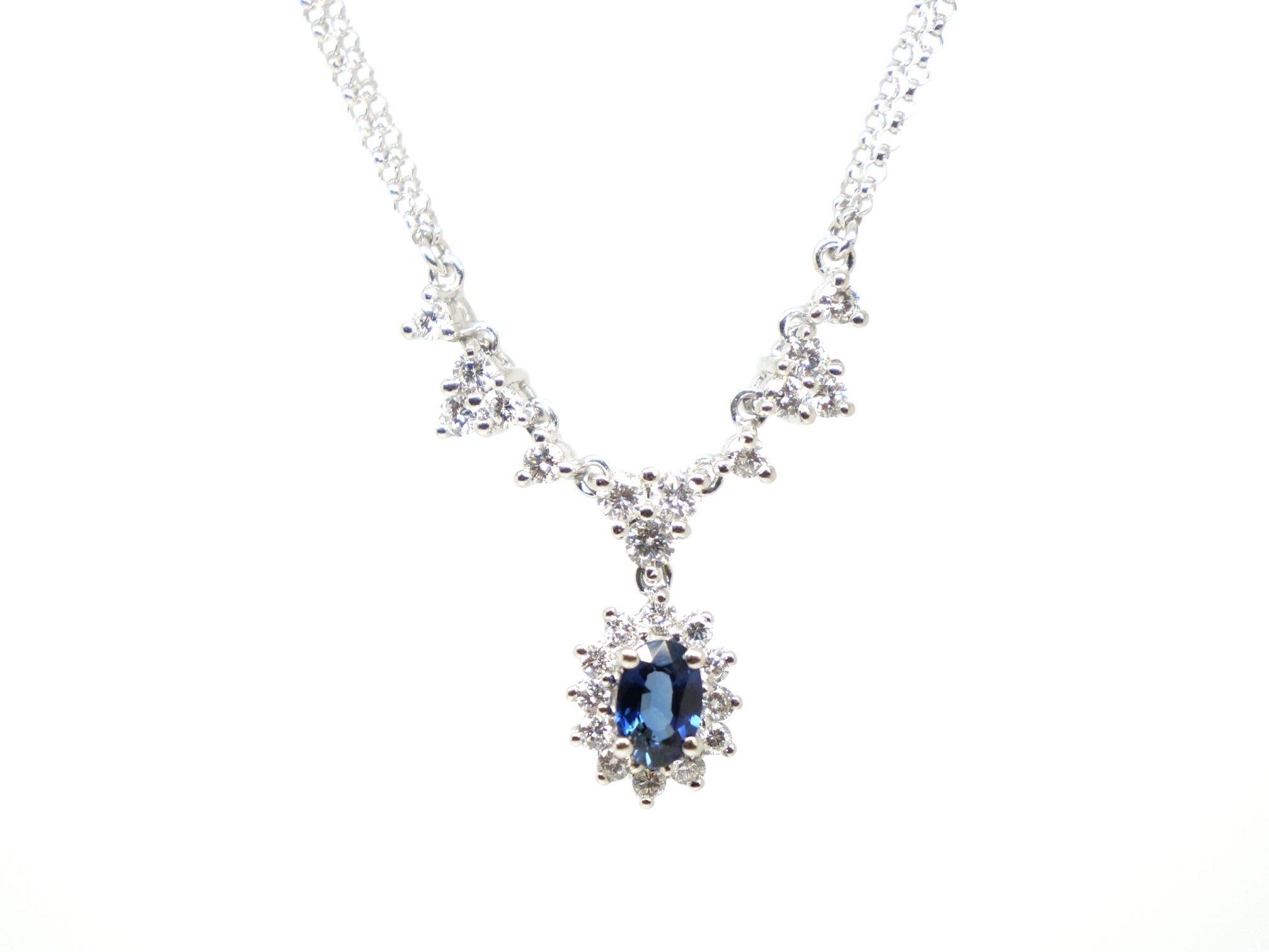 Stunning 14ct gold necklace, set with a lovely oval cut sapphire, which is surrounded by diamonds. Further diamonds set into necklace, with a double row chain.