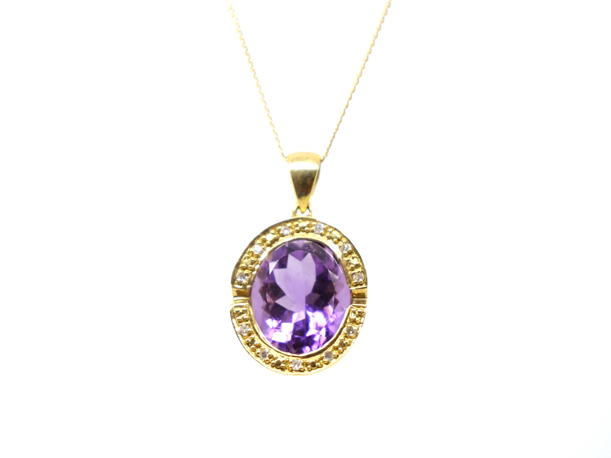 An 18ct gold pendant necklace with a large oval amethyst of approximately 4.5ct in a diamond-set halo.