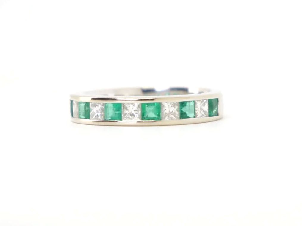 Unusual 18ct gold emerald and diamond half eternity ring, set with step cut emeralds of approximately 0.6ct and princess cut diamonds of approximately 0.6ct.