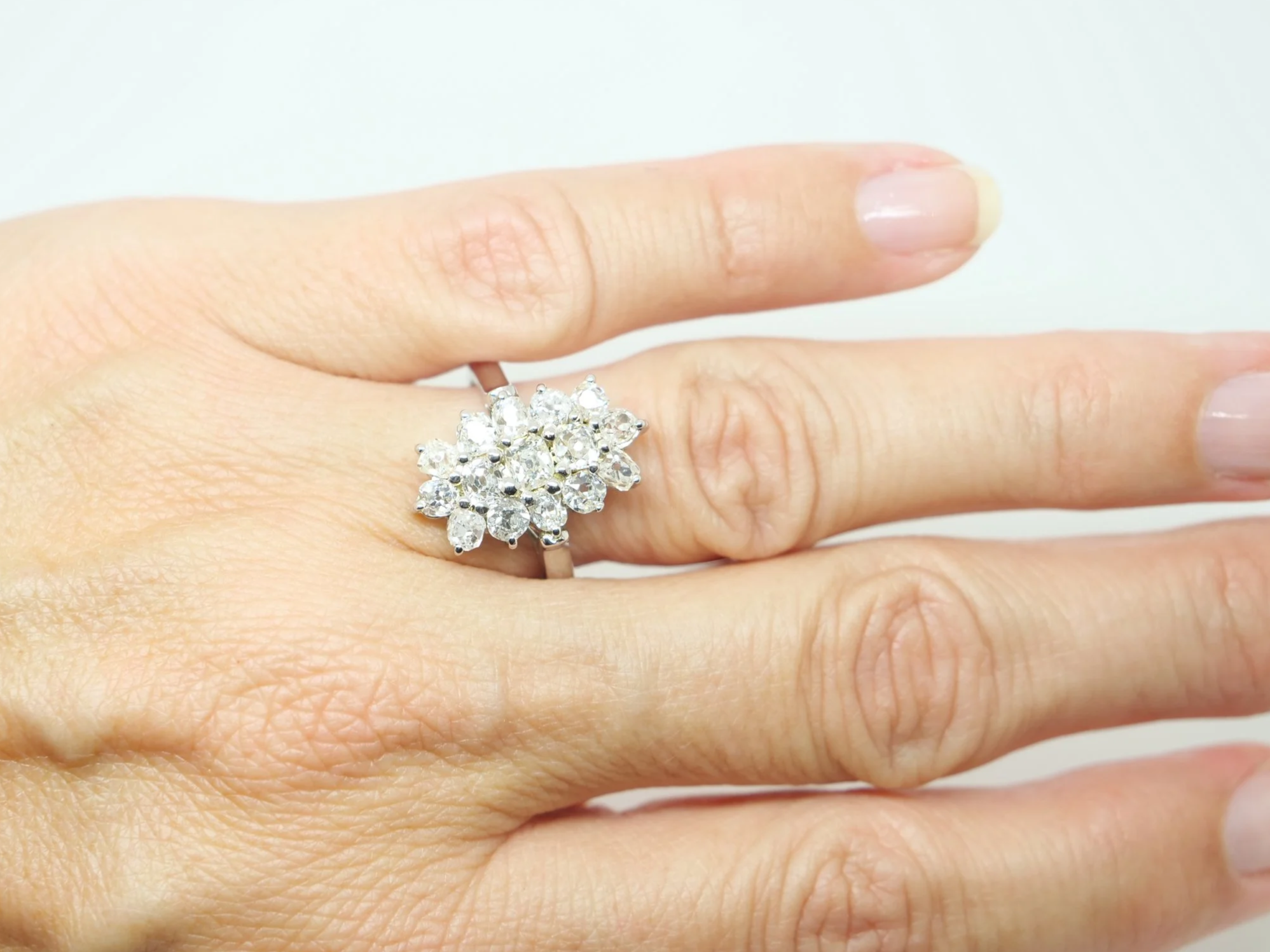 Stunning sparkly navette style ring, set with approximately two carats of old cushion cut diamonds.