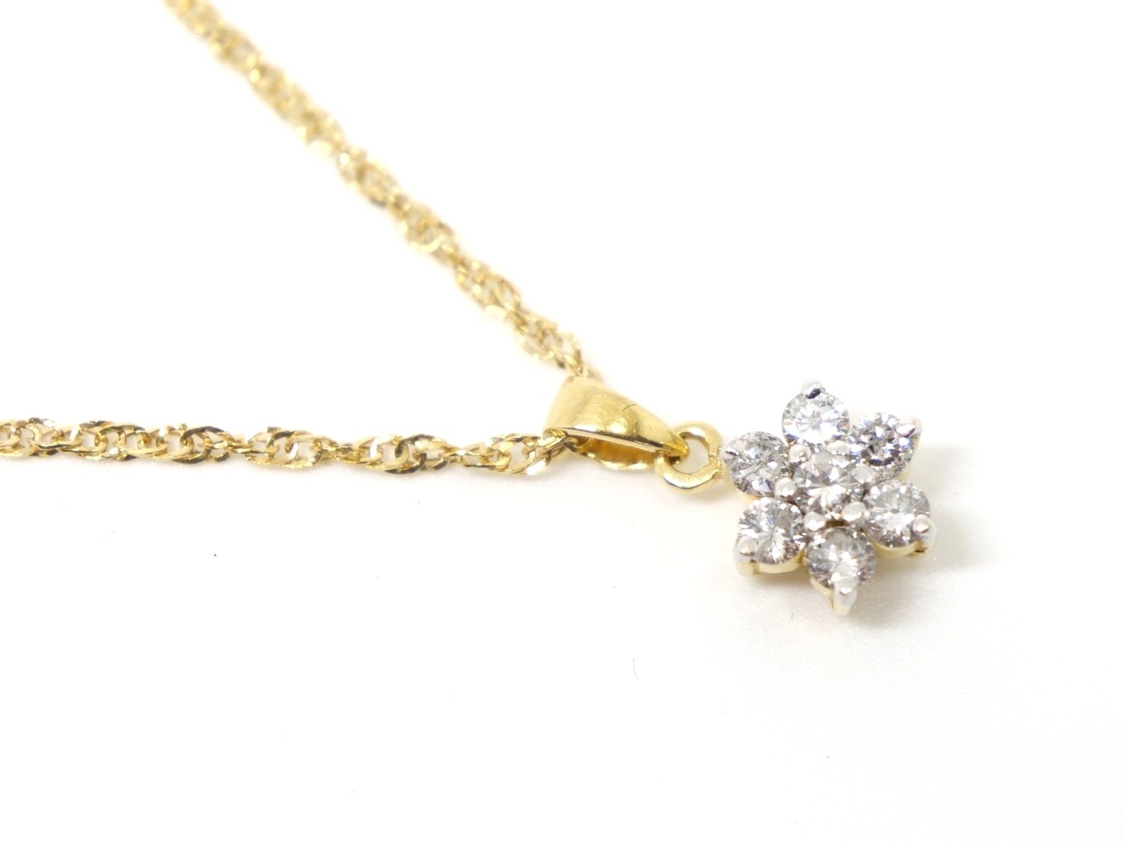 Classic 18ct gold diamond flower pendant, set with seven brilliant cut diamonds of 0.5cts. With pretty 9ct gold chain.