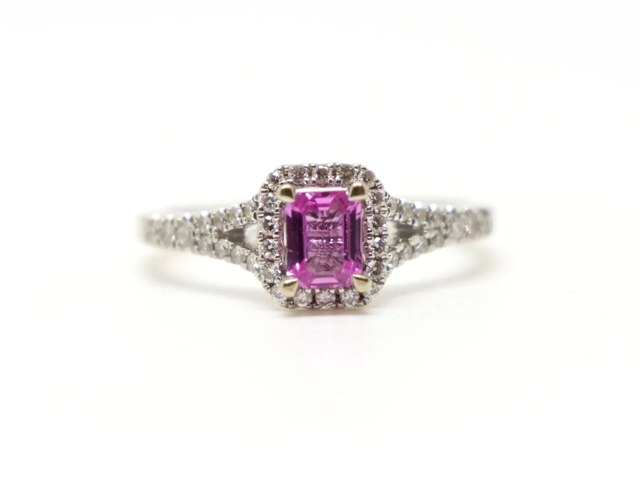Very pretty contemporary 18ct gold pink sapphire and diamond ring, set with an emerald cut pink sapphire with diamond halo. Split shank shoulders set with diamonds.