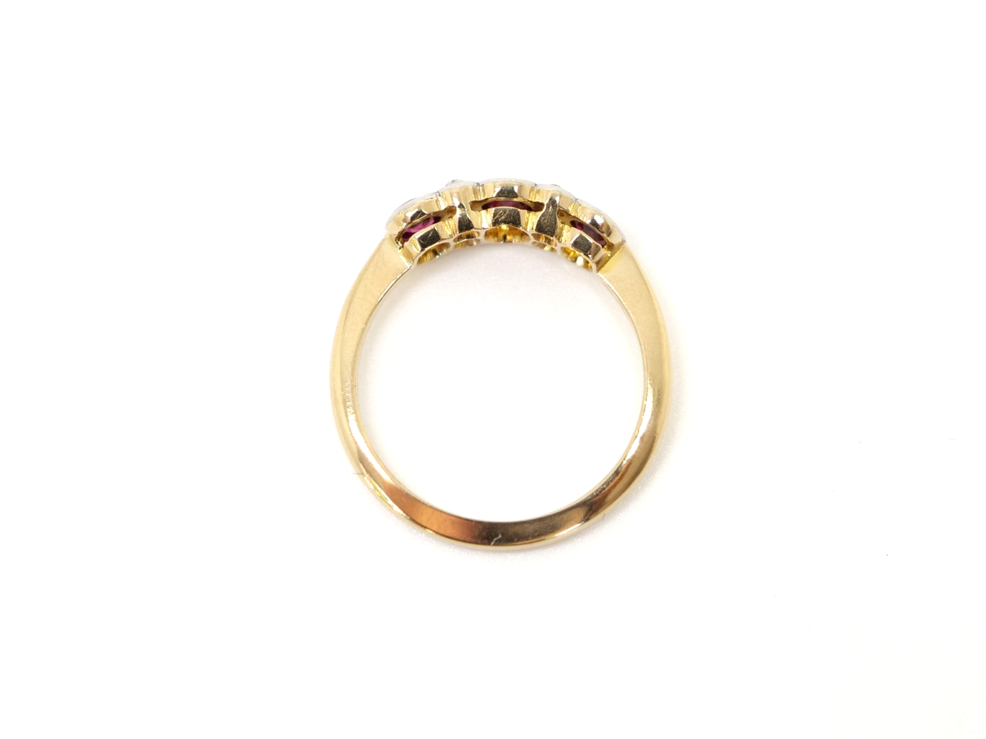 Vintage 18ct gold ruby and diamond ring, set with three oval cut rubies and inset with old cut diamonds.