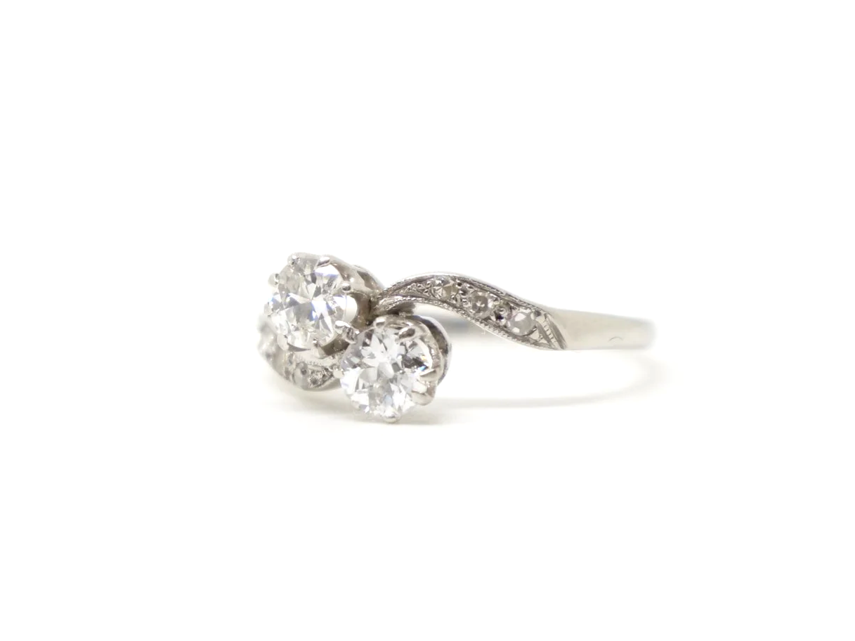 Super platinum diamond toi et moi ring, set with two old cut diamonds, with further diamonds set into each shoulder.