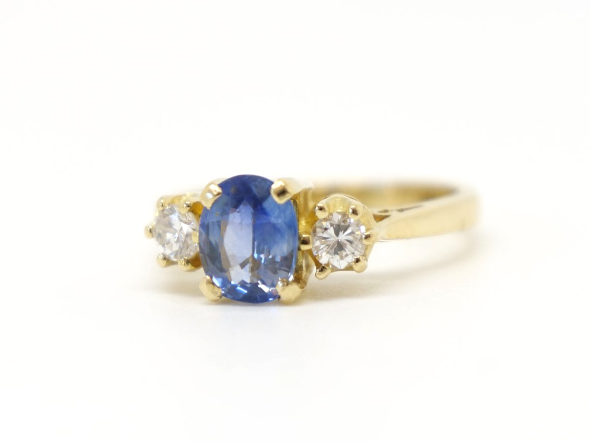 Lovely vintage 18ct gold sapphire and diamond trilogy ring, set with a 1ct oval cut emerald and with a brilliant cut diamond to each side.